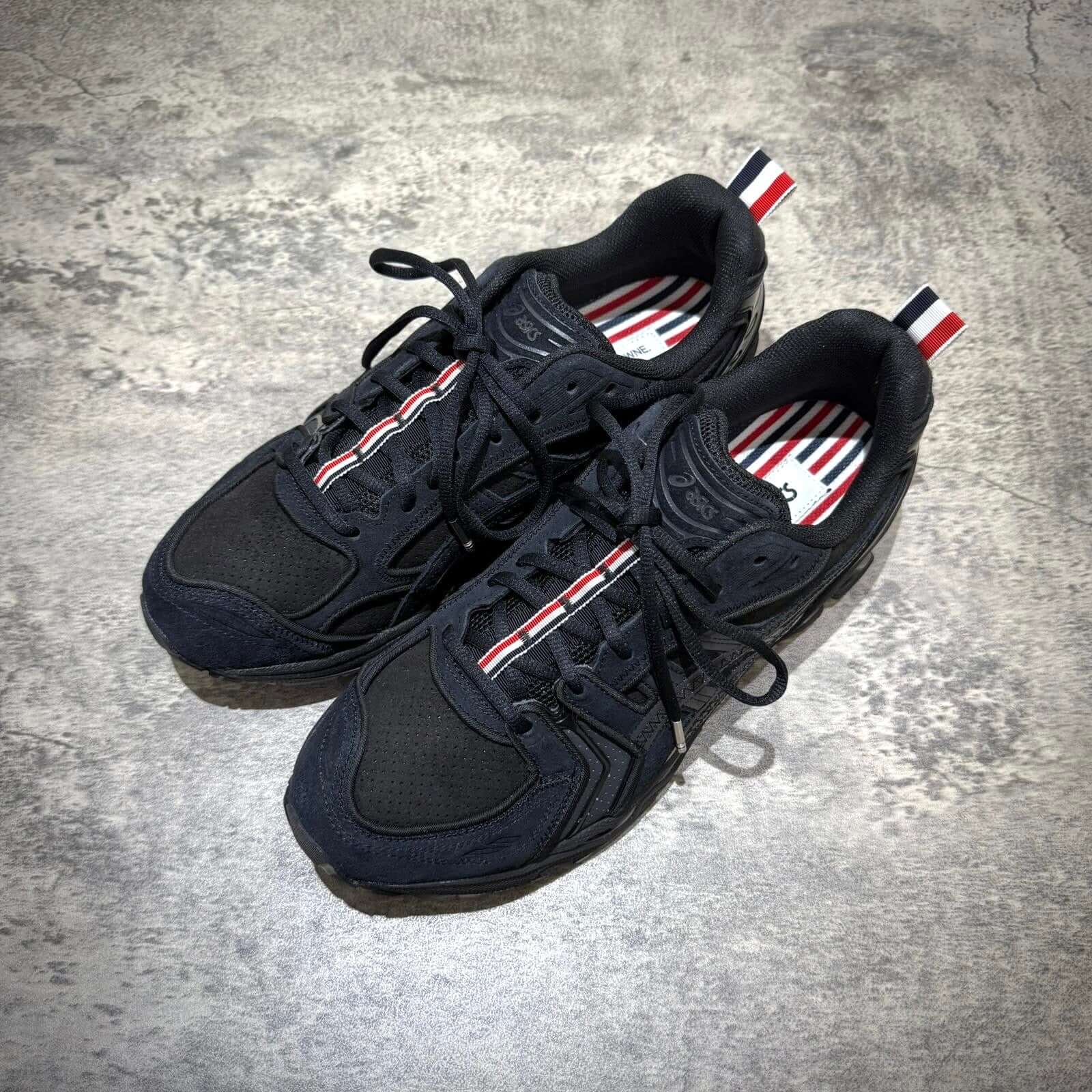 Thom Browne x Asics Gel-Kayano 14 in black, showcasing sleek design and iconic colors.