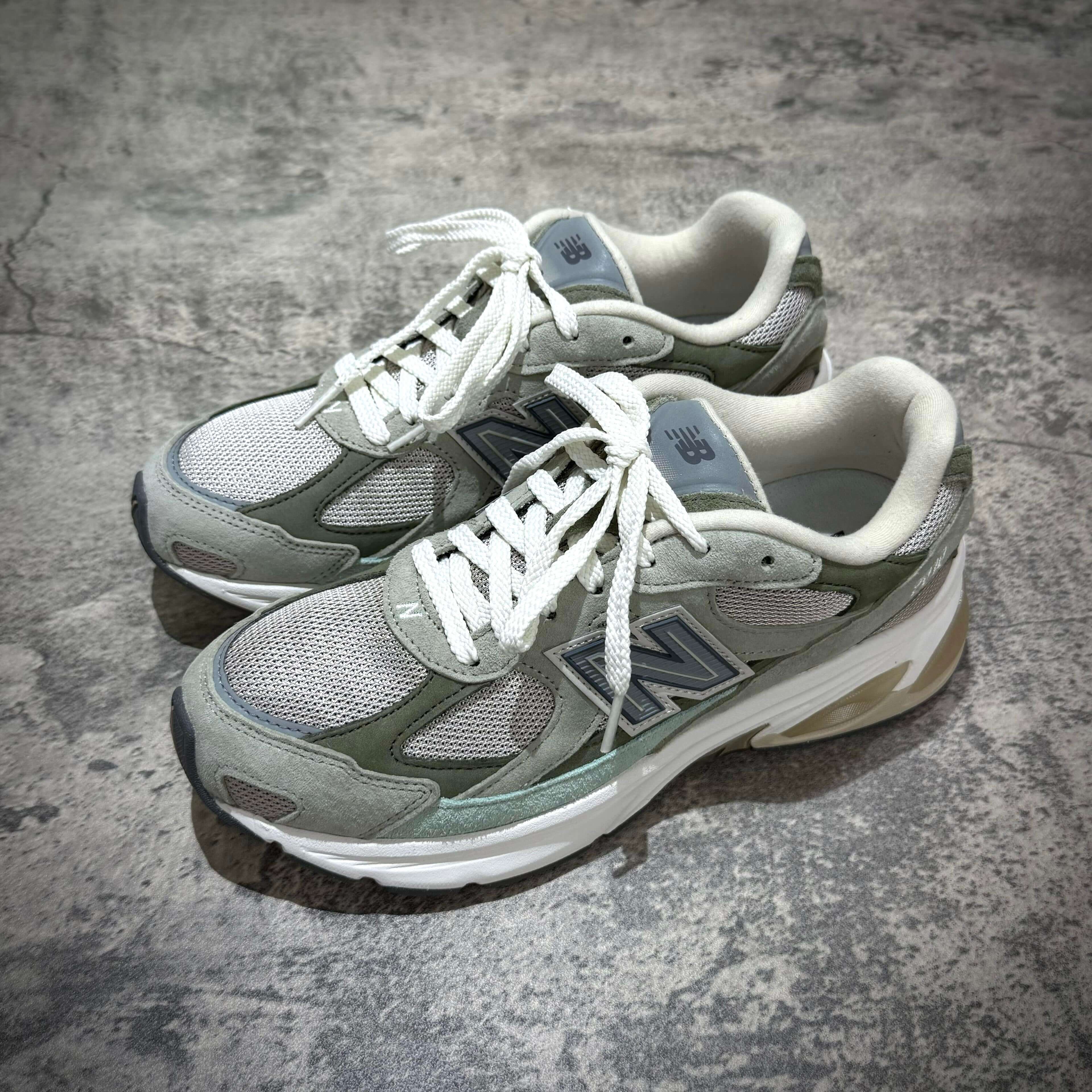 New Balance U20105K7 Wasabi Green sneakers displayed from the side on a textured surface.