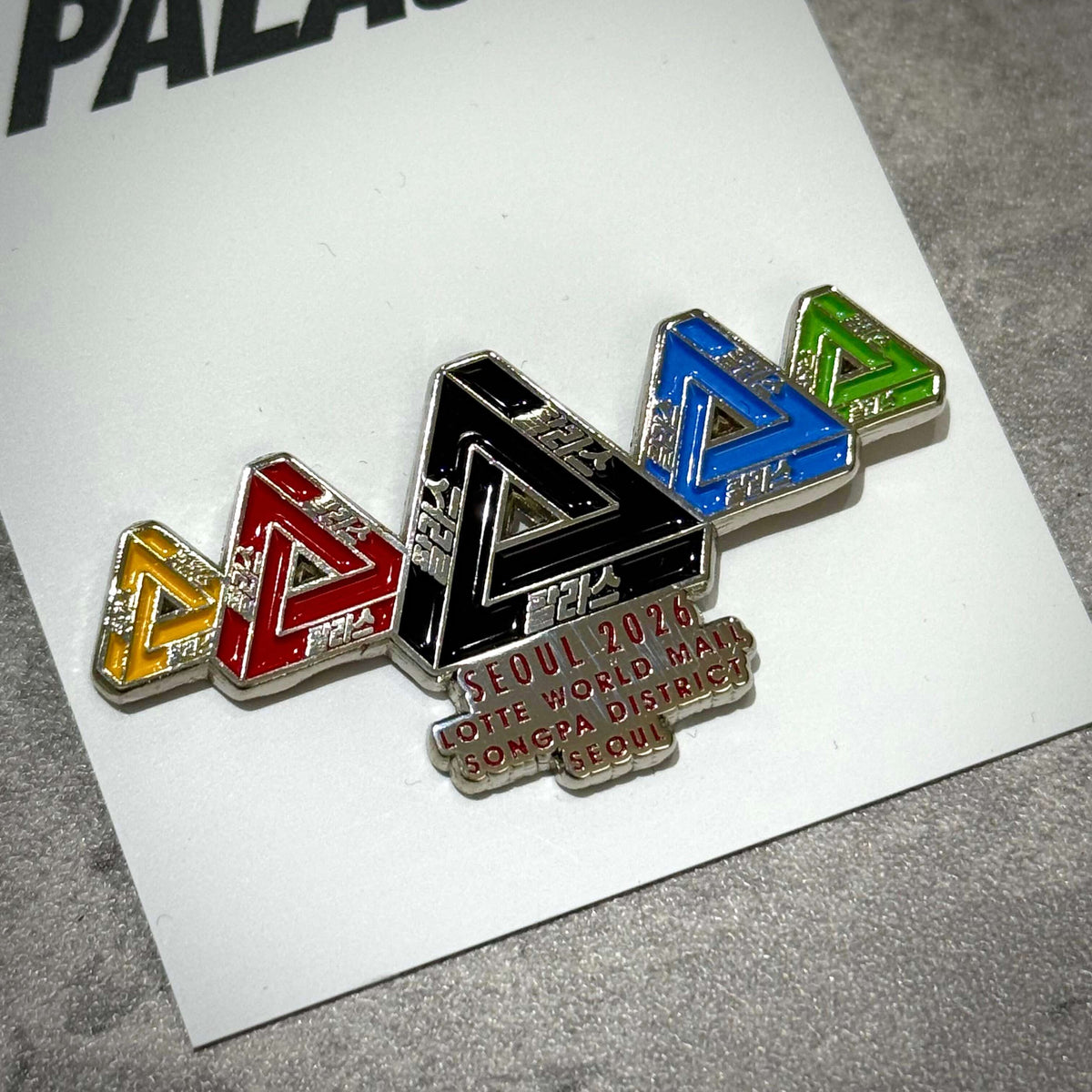 Palace Jamsil Exclusive Accessories pin with colorful triangle designs and Seoul 2026 text.