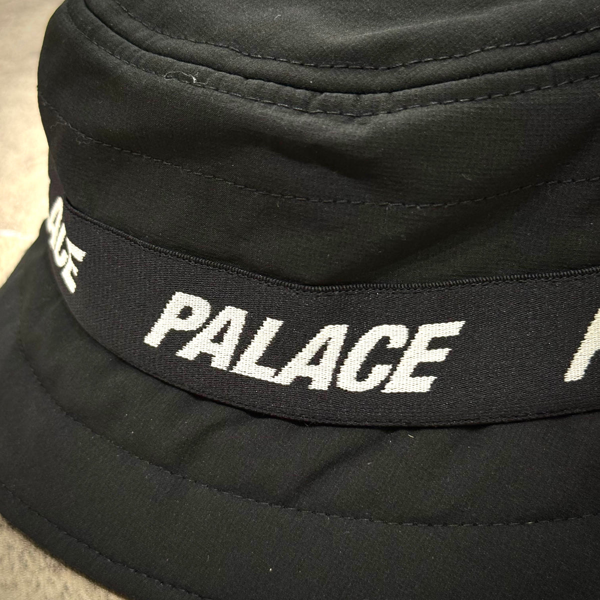 Palace Puffa Bucket - Black showcasing the logo detail on a stylish bucket hat.