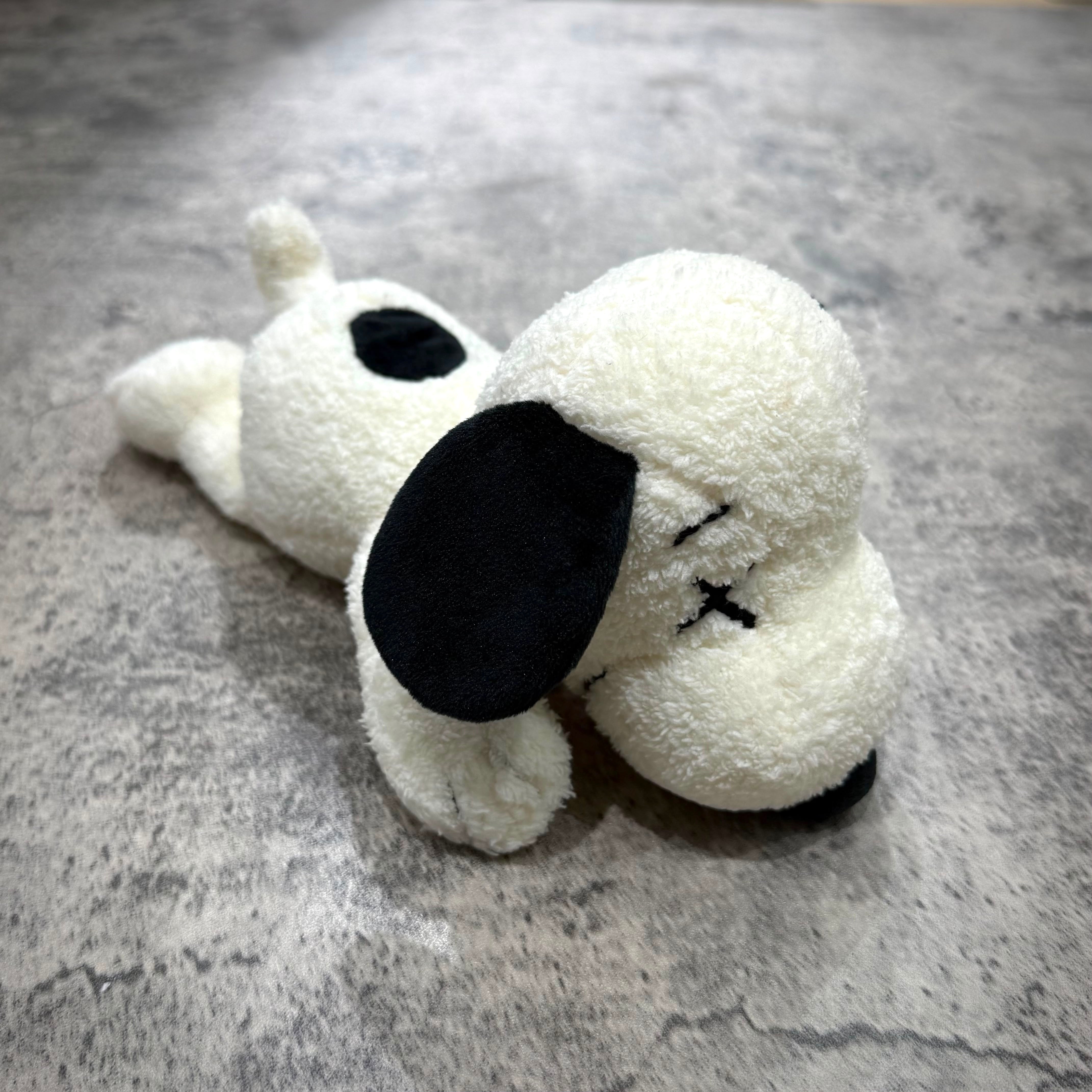 KAWS x Uniqlo x Peanuts Snoopy Plush (Small) - White, featuring red collar and black ears.