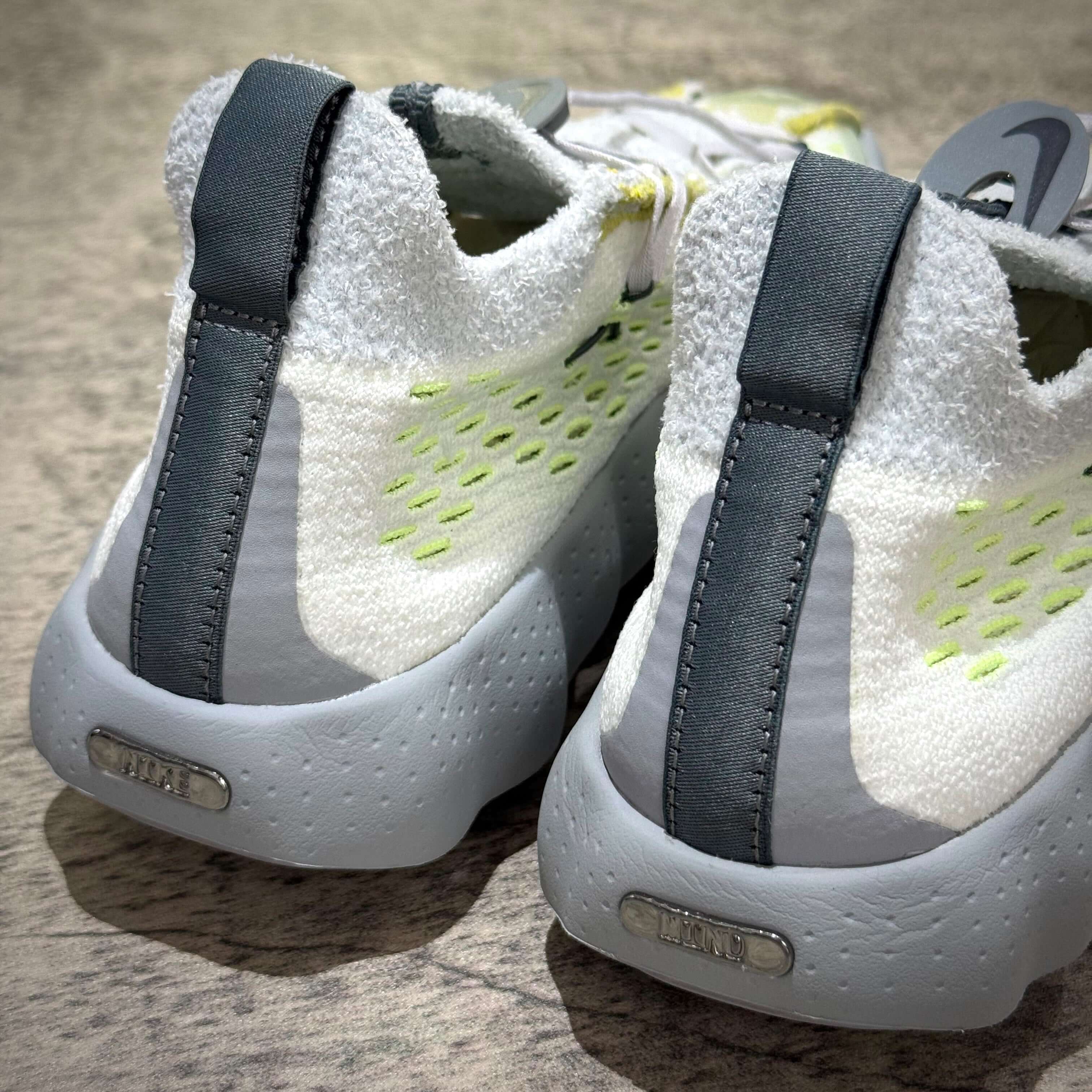 Nike Mind 002 Flyknit - Wolf Grey shoes featuring sleek design and modern material texture.