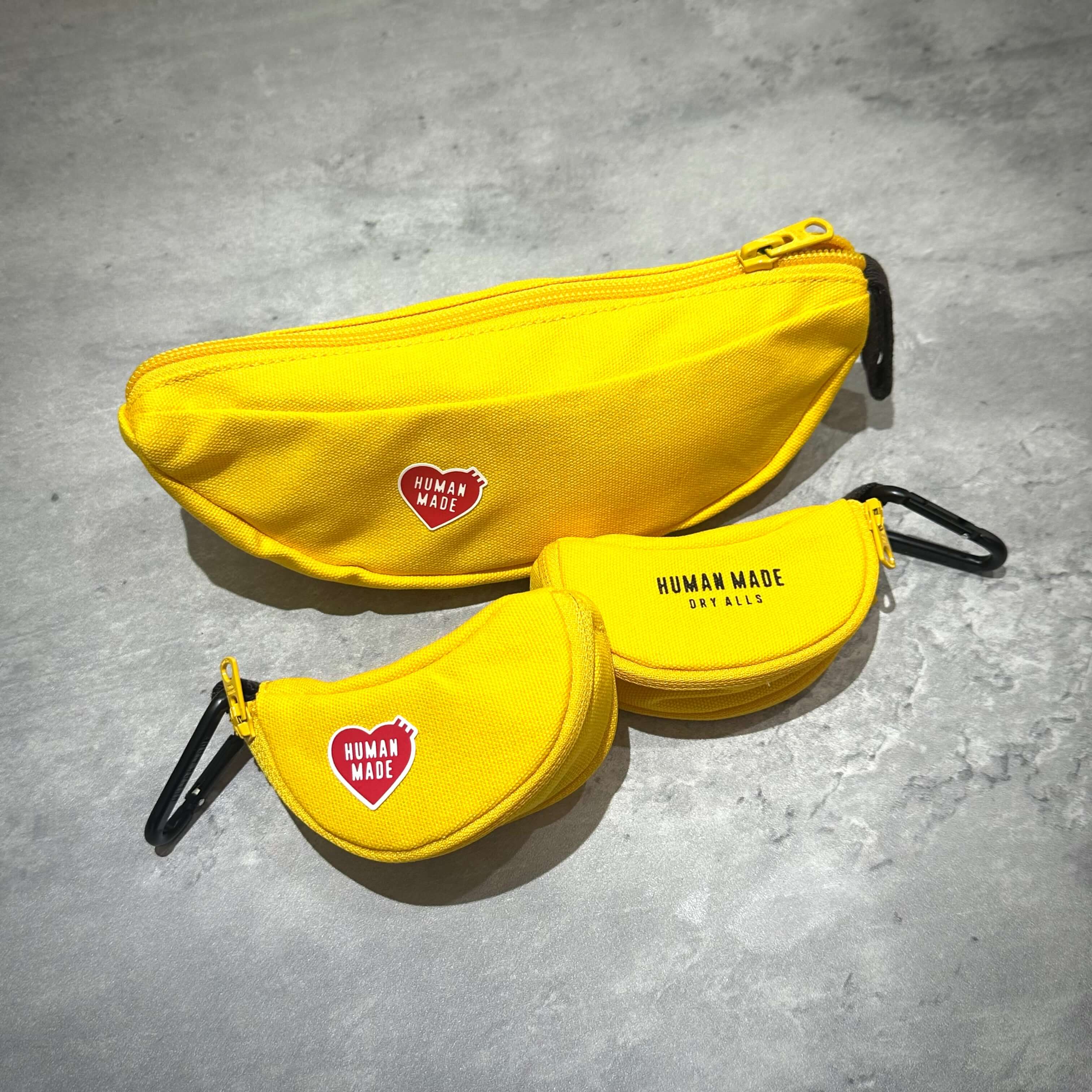 Human Made Banana Pouch - Small / Large displayed in vibrant yellow color on a gray surface.