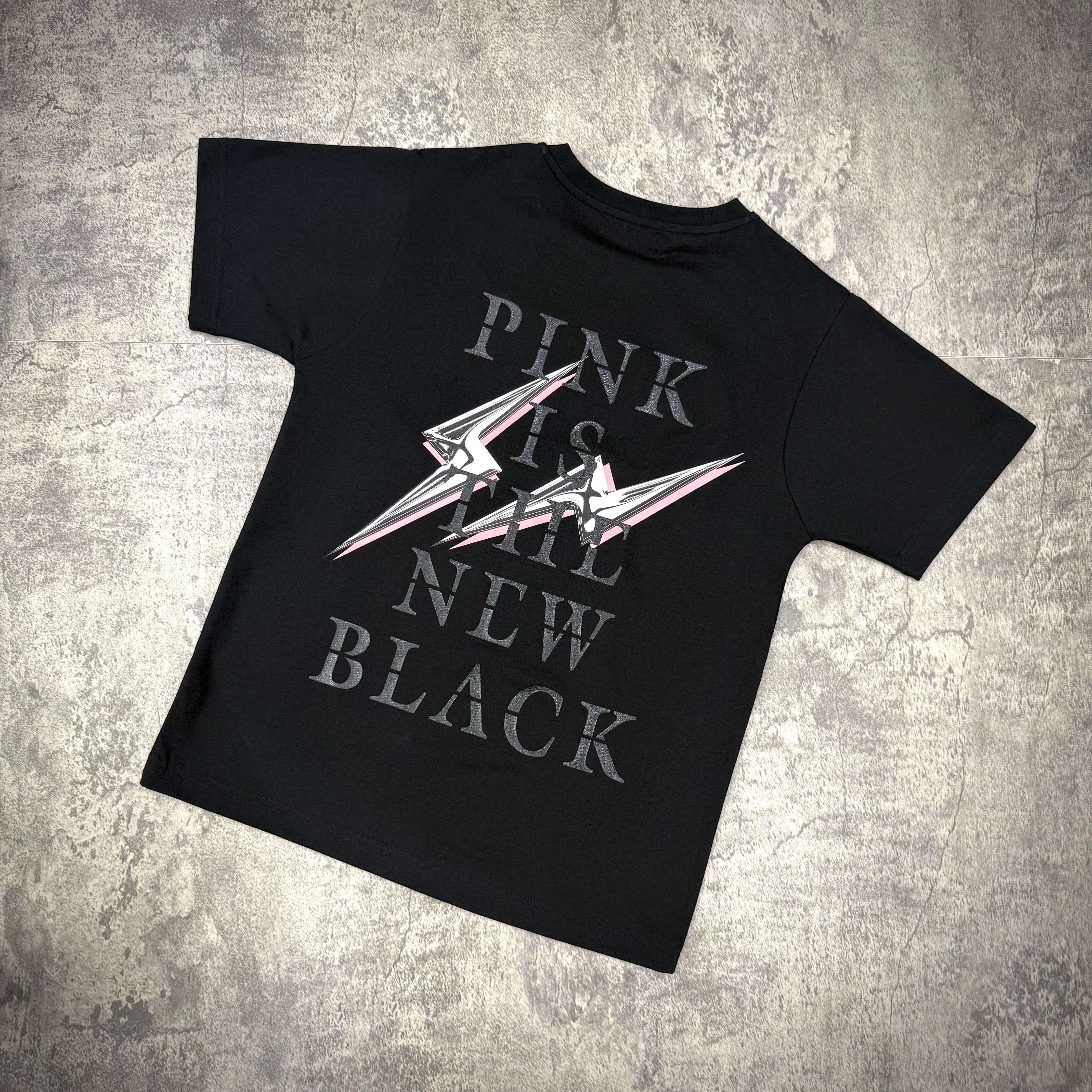Fragment x Blackpink Thunder Tee featuring graphic text 'PINK IS THE NEW BLACK' on black cotton tee.