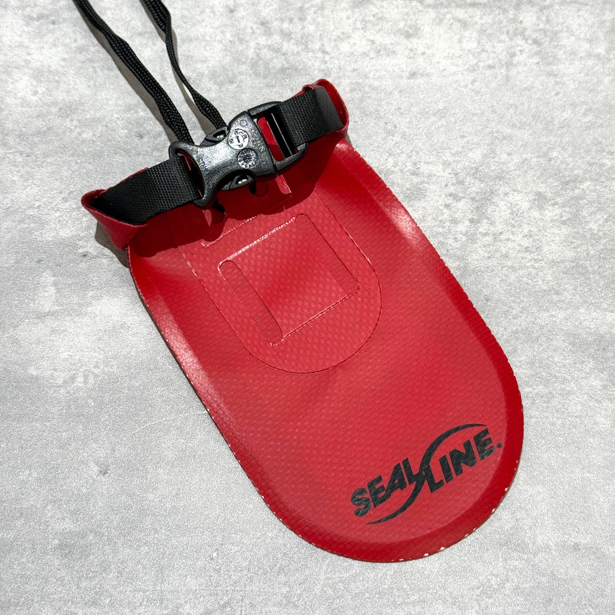 Supreme SealLine See Pouch Small Red with adjustable strap and logo on textured surface.