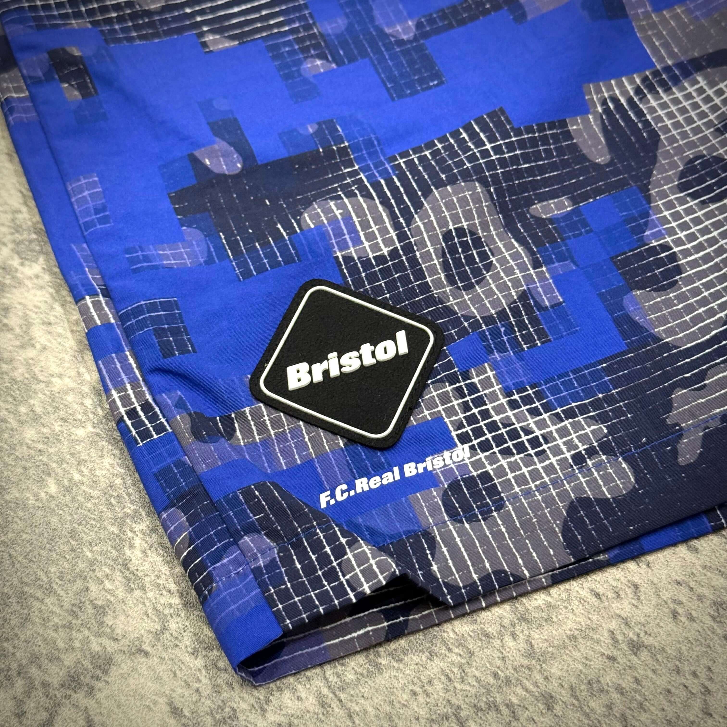Fragment x FCRB Camouflage Nylon Shorts featuring blue camouflage pattern and F.C. Real Bristol logo.