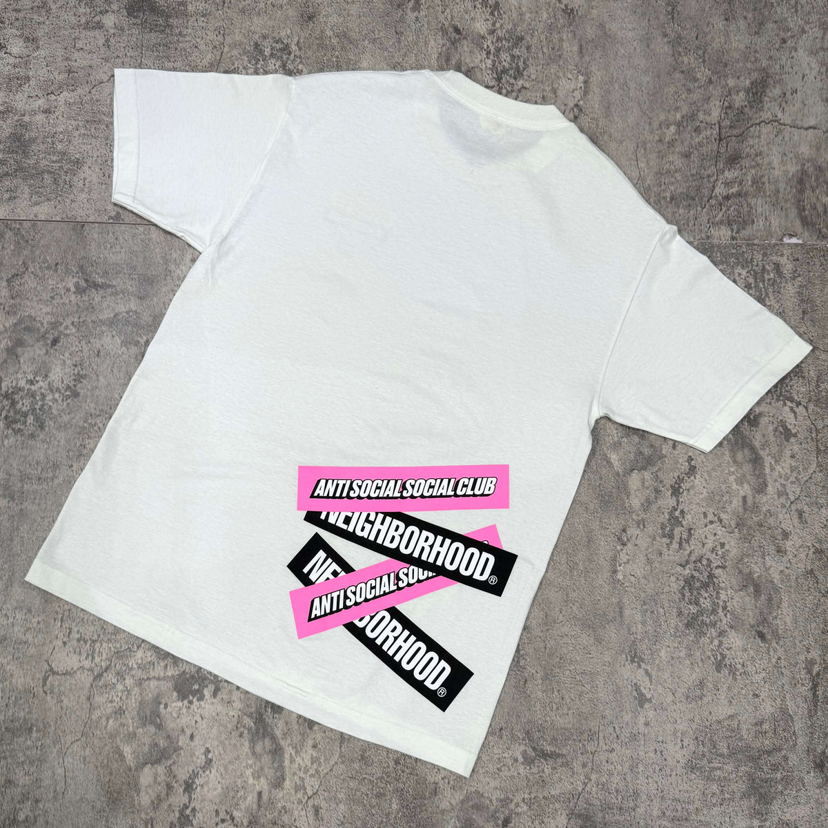 Anti Social Social Club x Neighborhood Stuck On You Tee featuring bold logos on the back in white and vibrant colors.