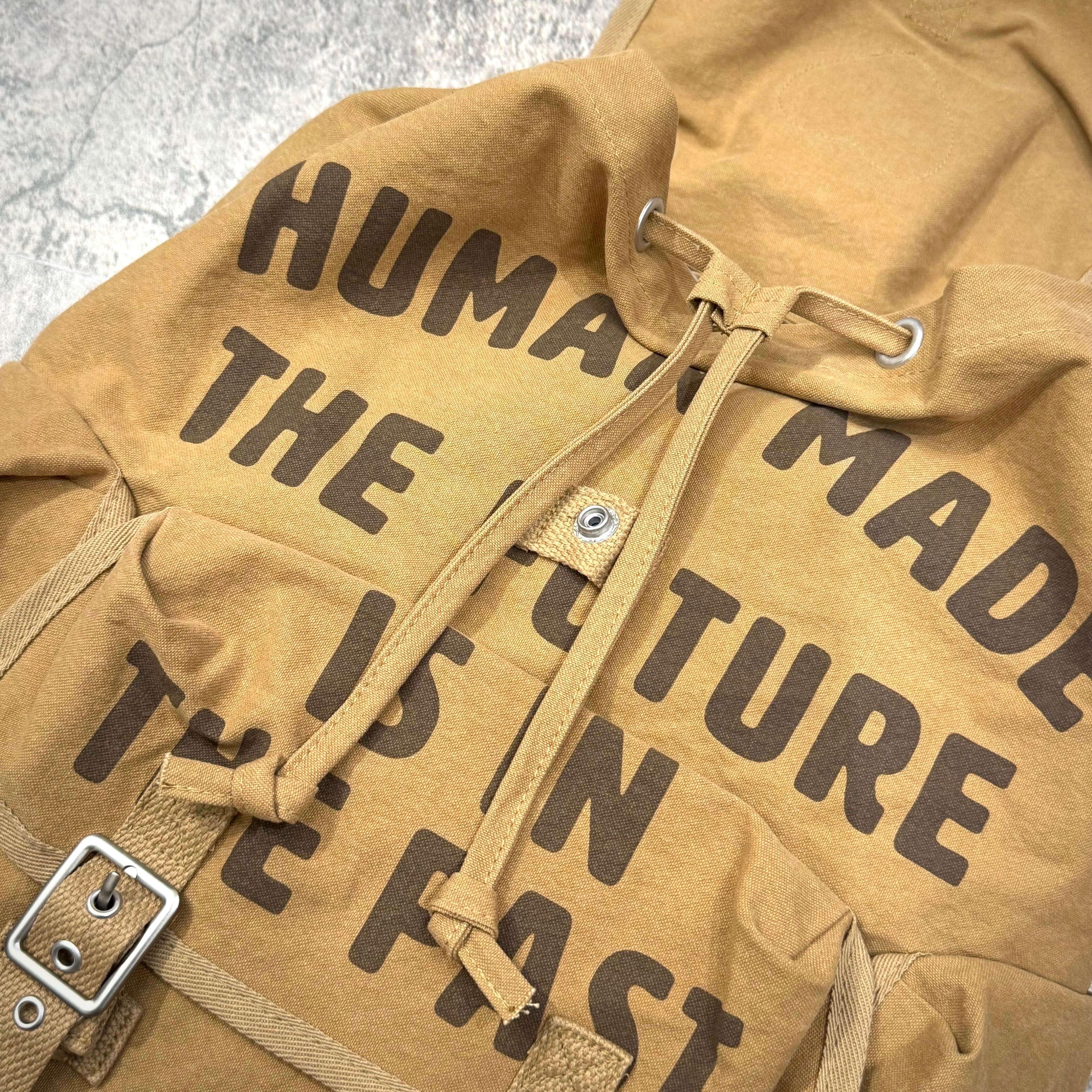 Human Made Hunting Backpack with unique text design on fabric, showcasing its brand identity and craftsmanship.