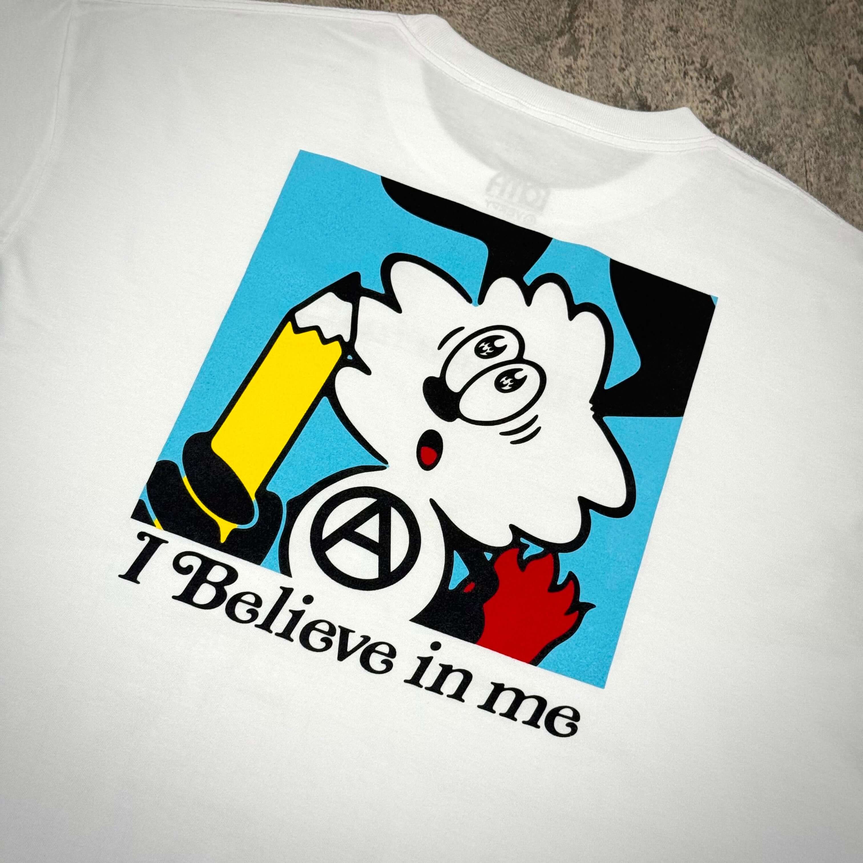 I Believe in me graphic print on white T-shirt featuring cartoon character and pencil design.