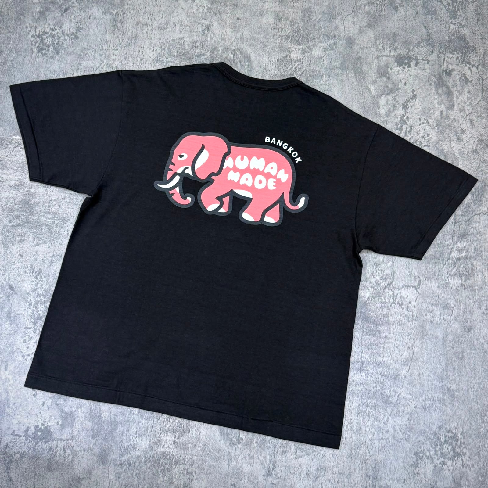 Human Made Bangkok Exclusive Elephant Back Logo Tee showcasing a playful elephant graphic design on a black t-shirt.