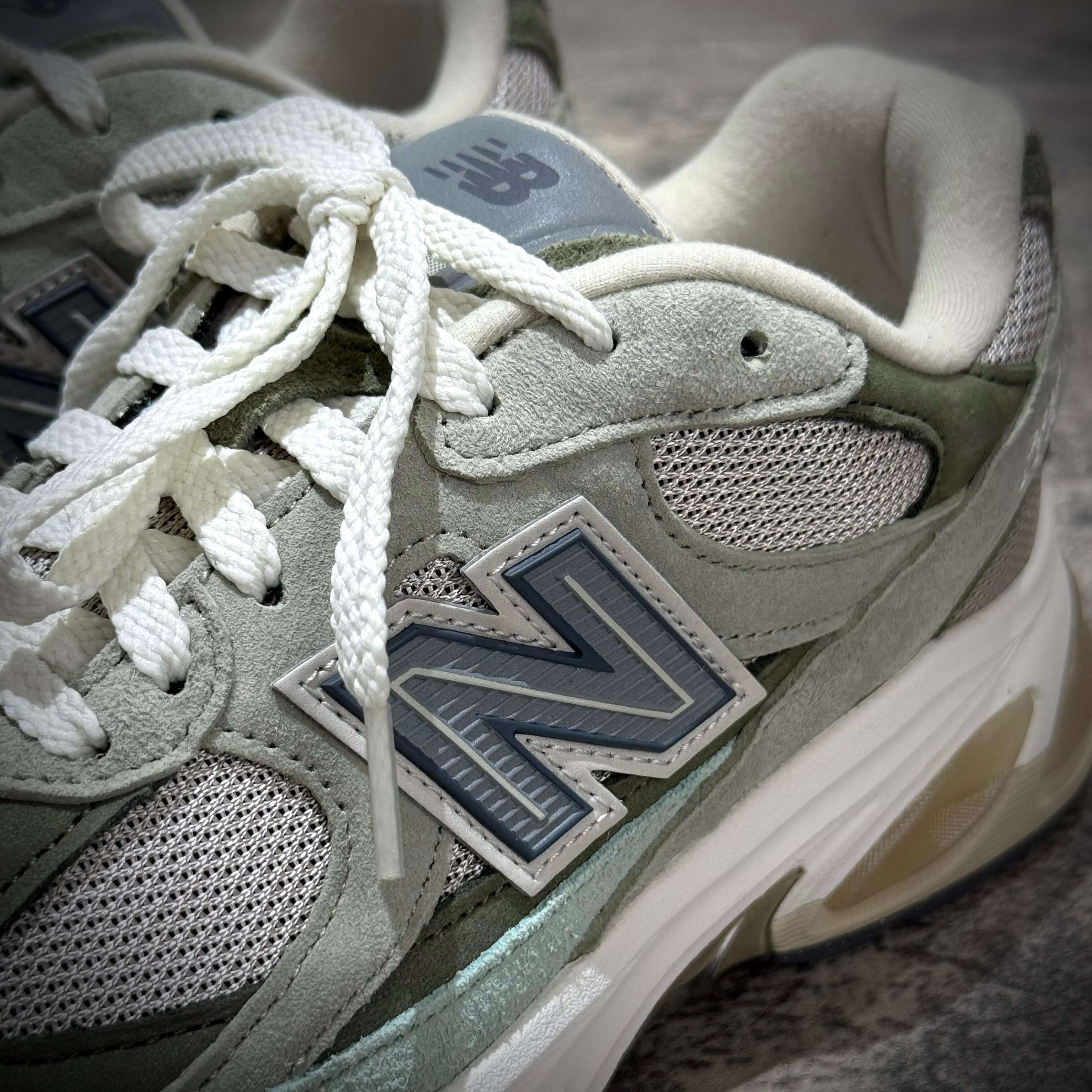 New Balance U20105K7 Wasabi Green sneakers featuring light green suede and mesh design close up.