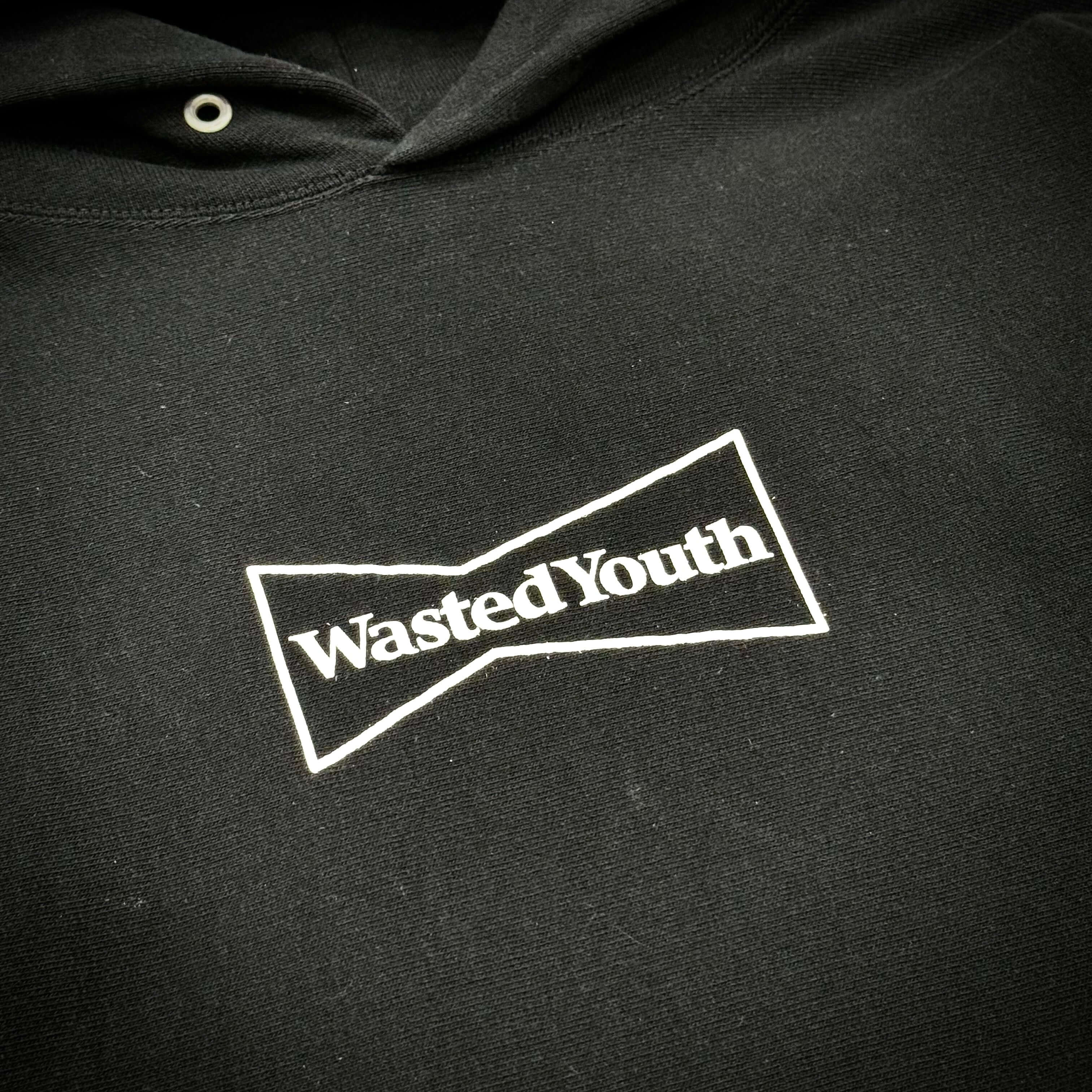 Wasted Youth Hoodie - Black close-up featuring the logo on the front.