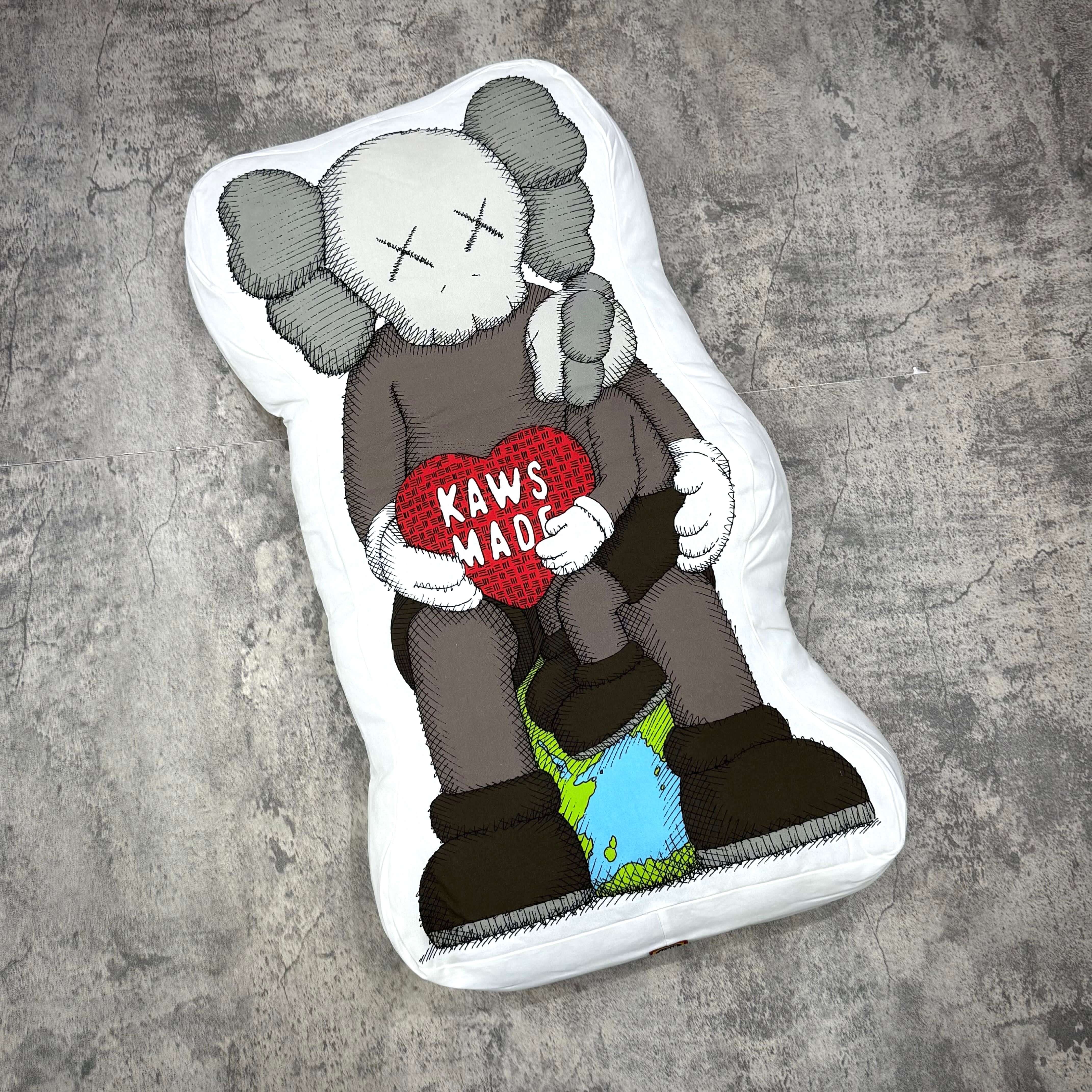 Human Made Bangkok Exclusive Kaws Made Cushion featuring KAWS character with heart design on an eco-friendly base.