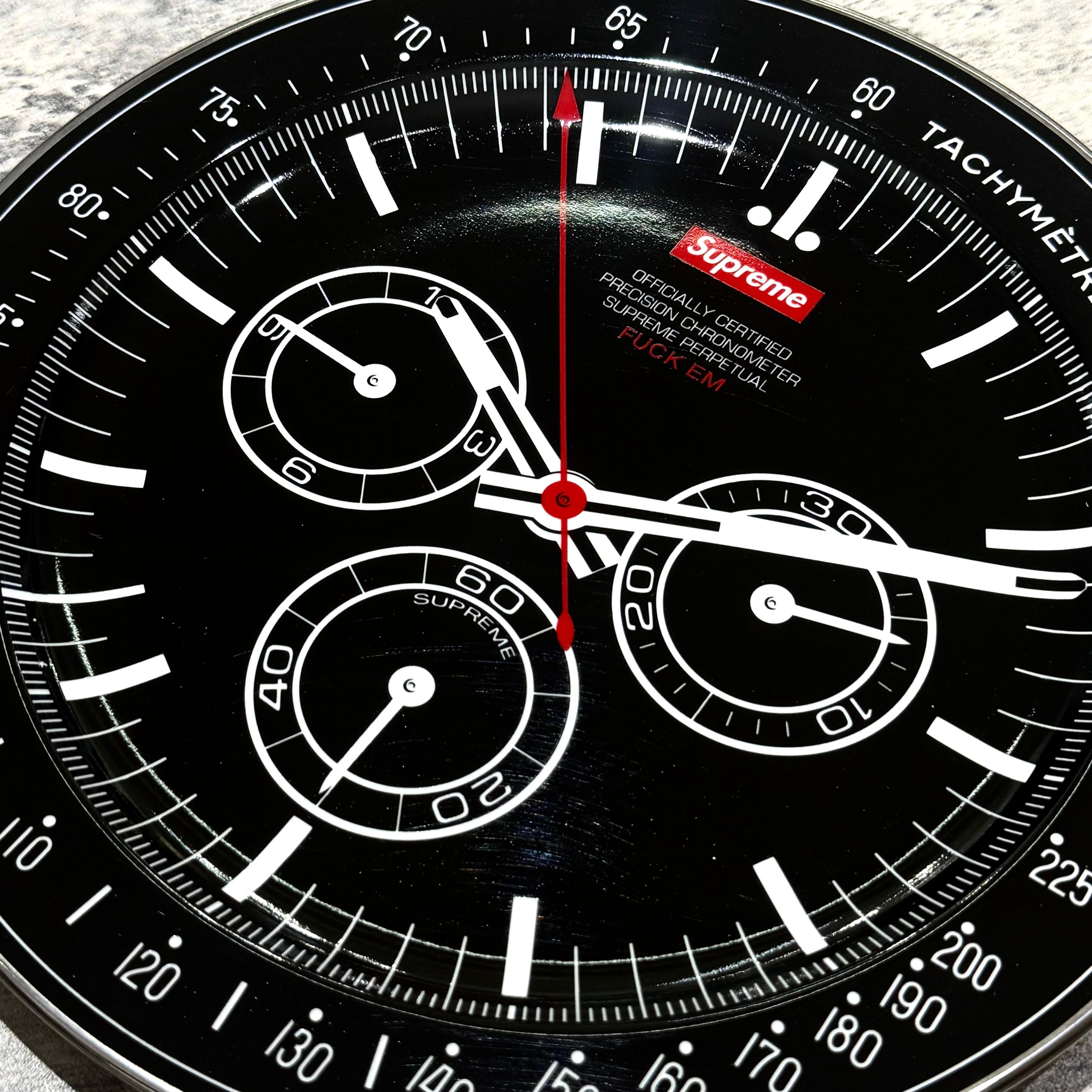 Supreme Watch Plate - Black with tachymeter and chronograph features, showing detailed graphic and red accents.