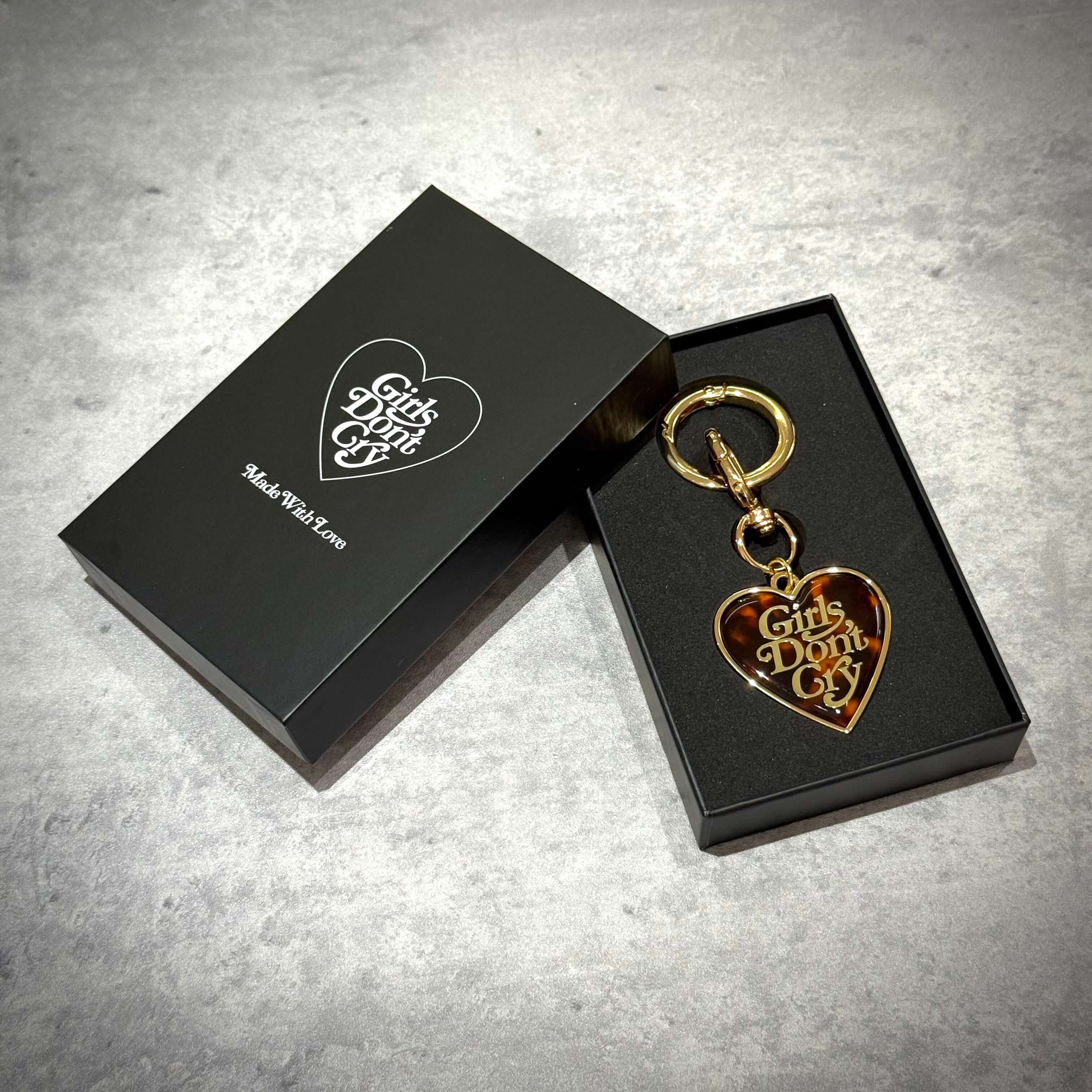 Girls Don't Cry Tortoise Shell Keyring displayed in a black box with heart-shaped design.