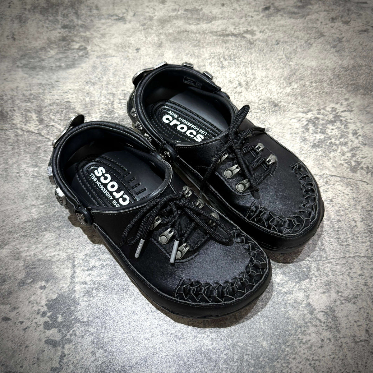 ANDERSSON BELL x Crocs Classic Clog in black, featuring a unique woven design and lace-up closure.