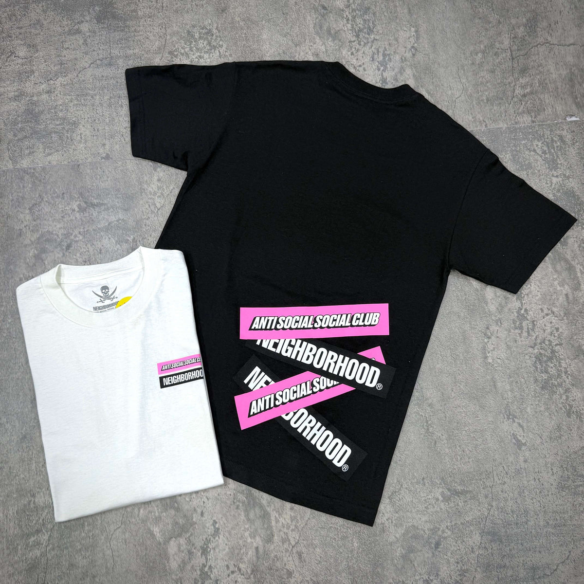 Anti Social Social Club x Neighborhood Stuck On You Tee featuring black and white tees displaying distinct logo designs.