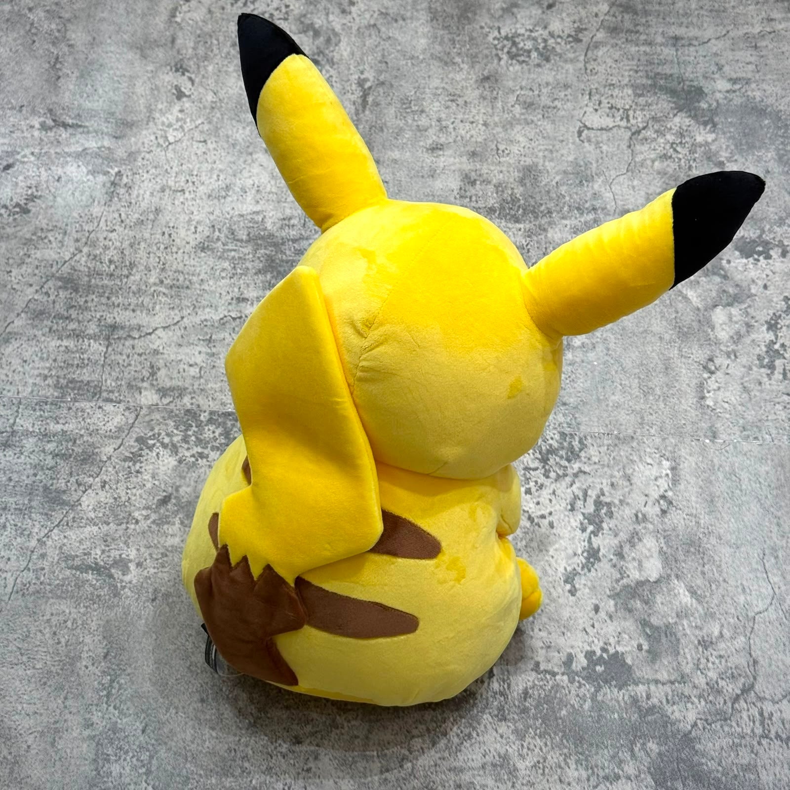 Pokemon x Thunderbolt Project by Fragment Pikachu Plush viewed from behind, showcasing its iconic features.