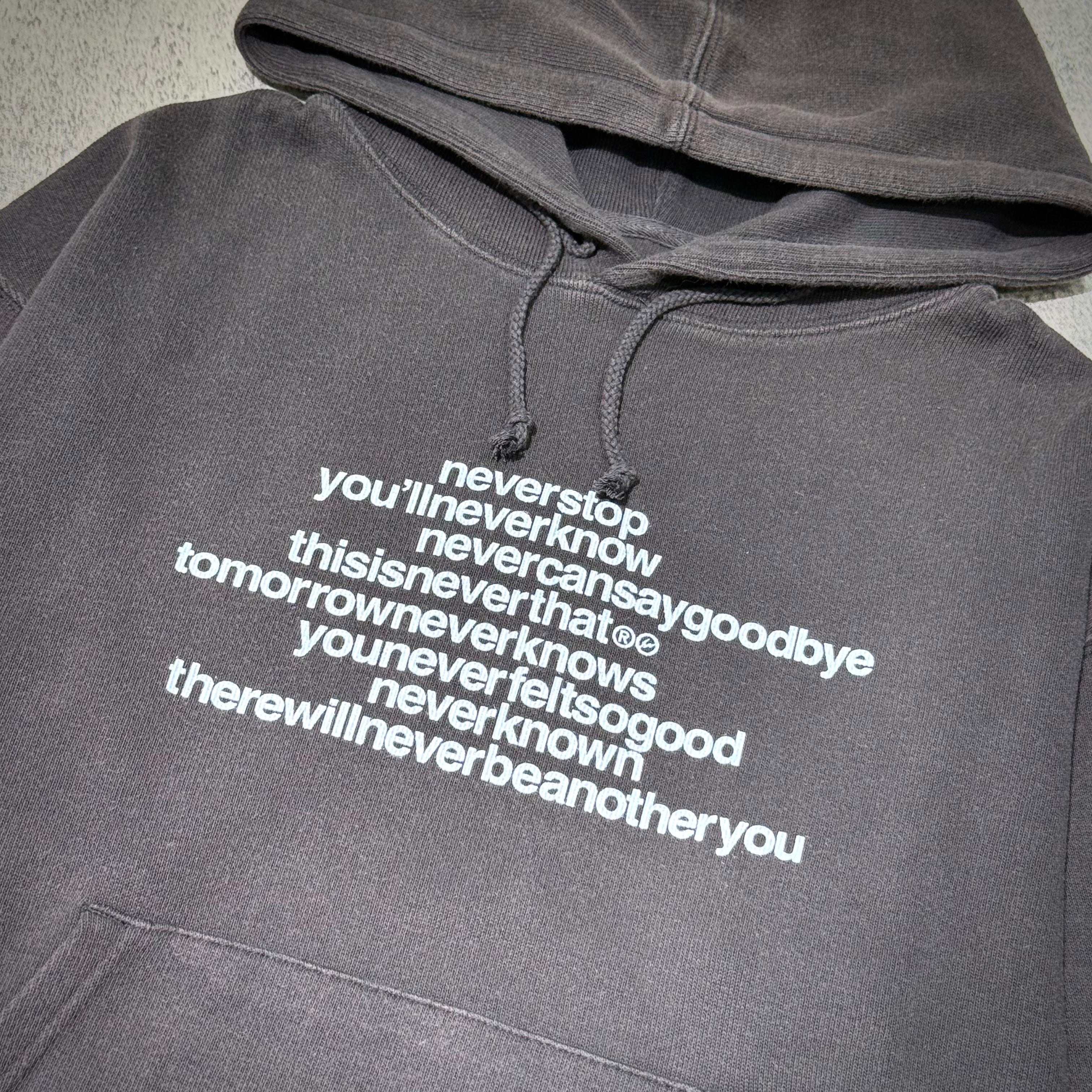 thisisneverthat x Fragment Design Hoodie- Off Black with motivational text design in white on a dark background.