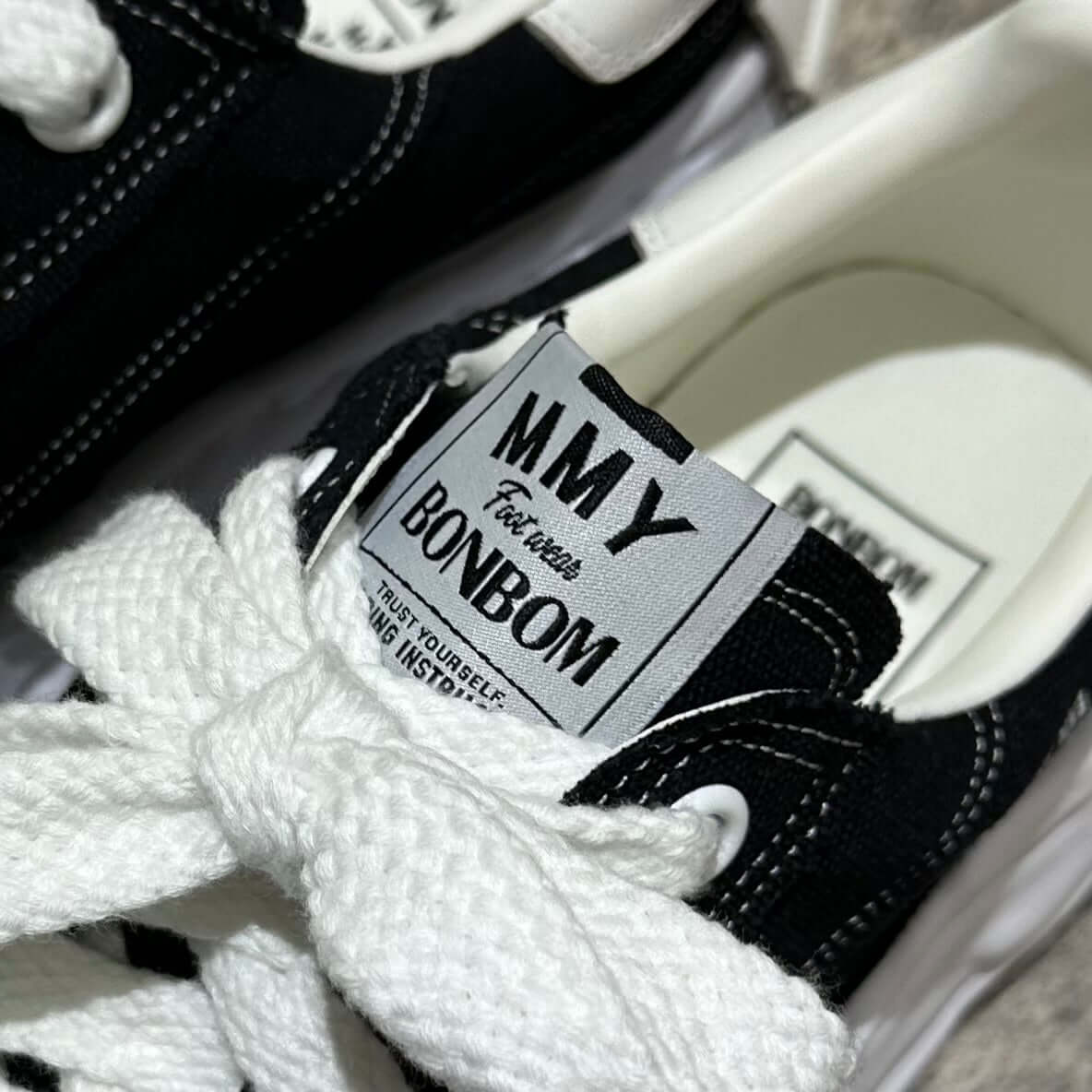 Close-up of the BONBOM x MMY BLAKEY OG Canvas - Black showing logo and laces.