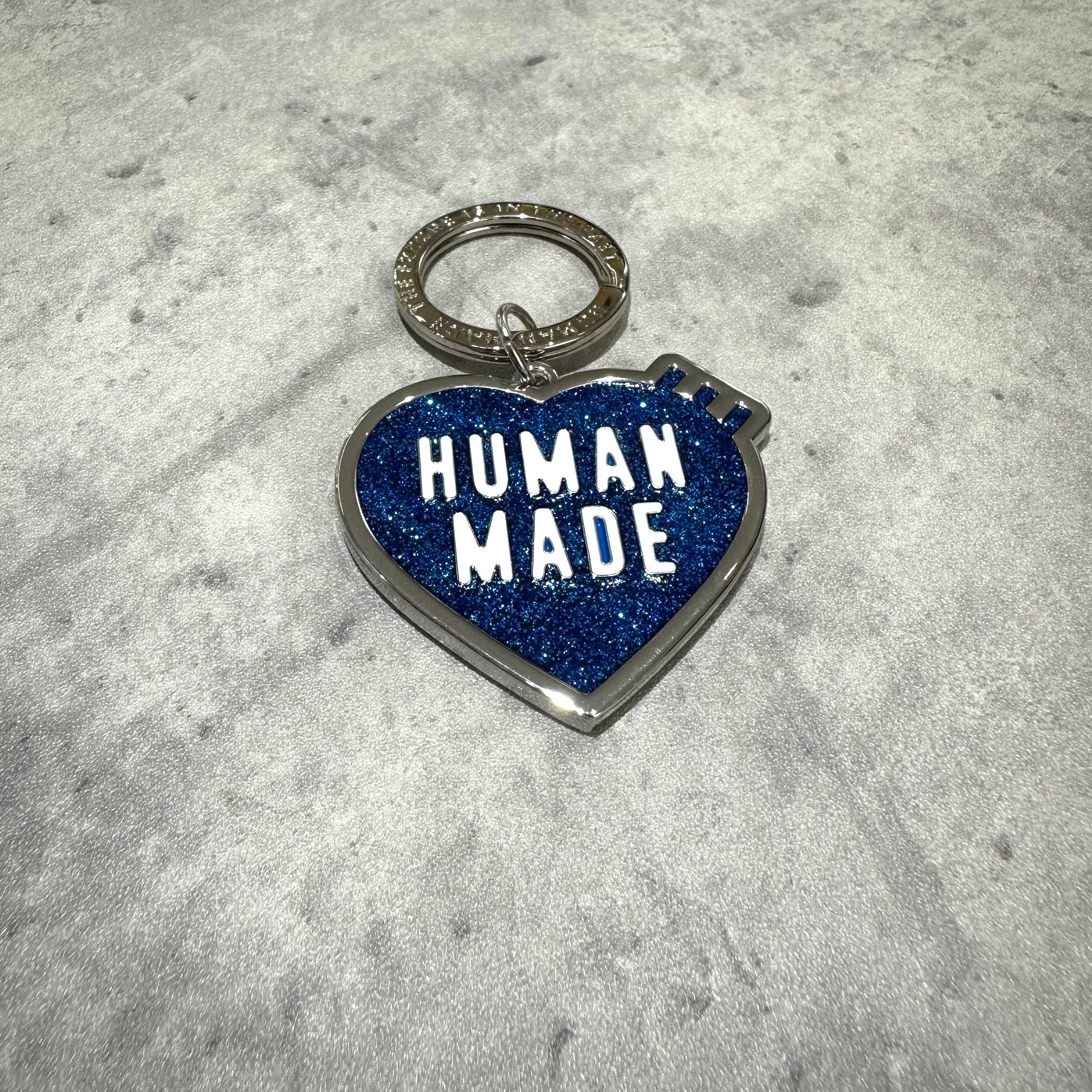 Human Made Store Exclusive Heart Keychain with blue glitter finish and keyring, showcasing bold text 'HUMAN MADE'.