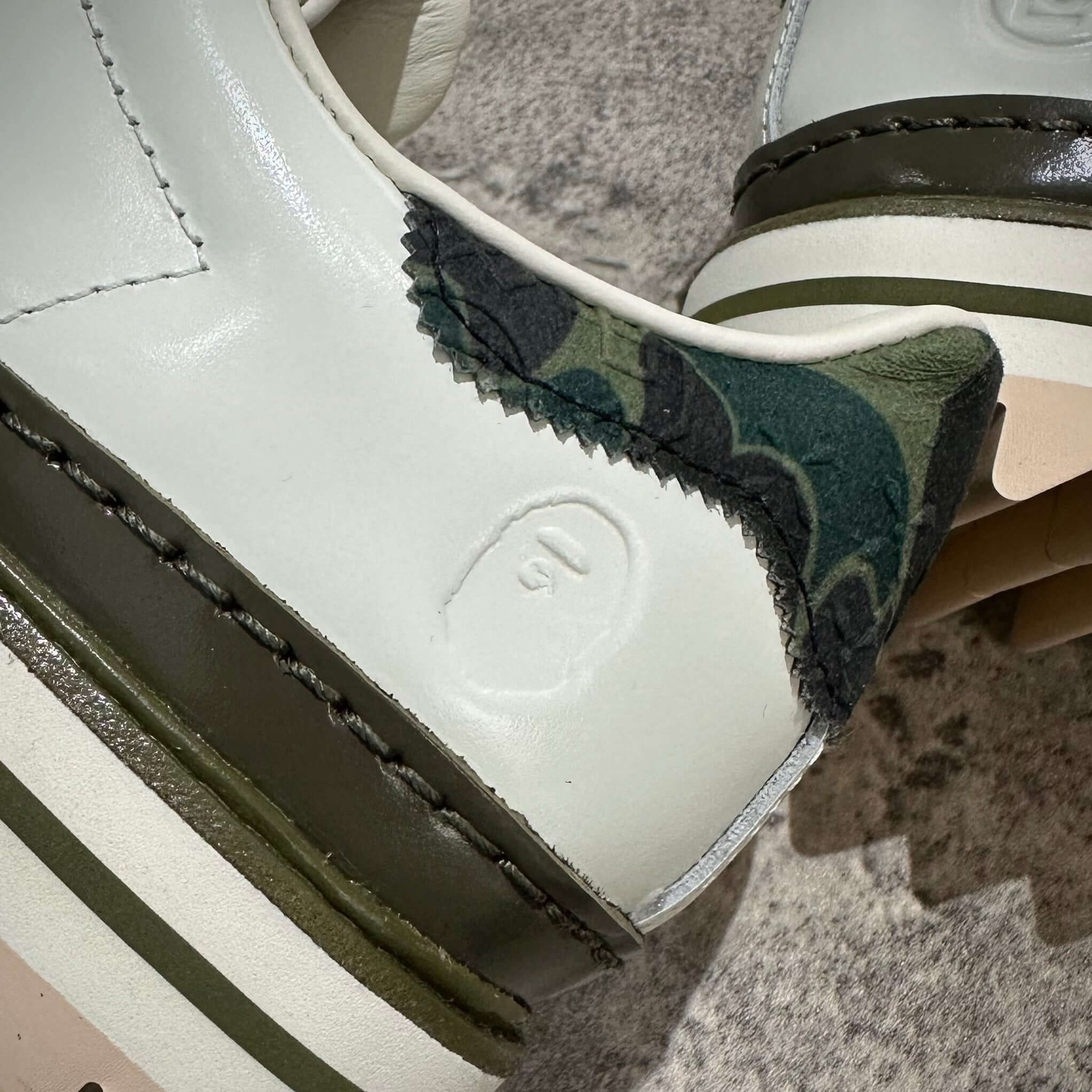 現貨 CLOT x BAPE x Adidas Superstar 鞋款近照,展示綠色迷彩與白色皮革細節