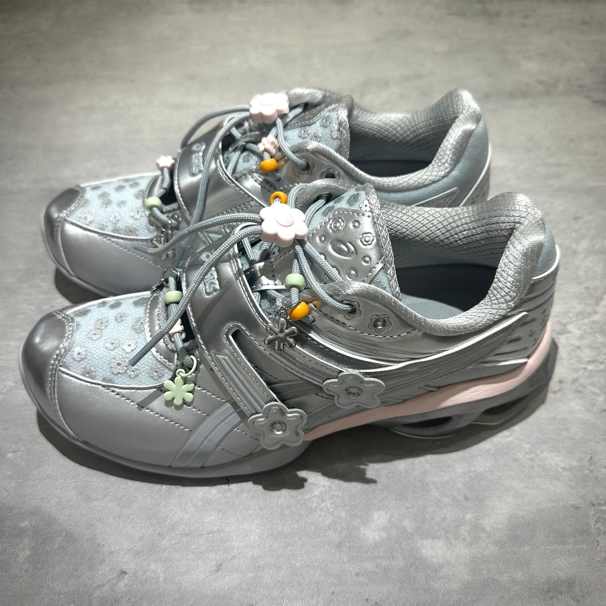 Cecilie Bahnsen x Asics Gel-Kinetic FR - Pure Silver 1203B171-020 sneakers with floral embellishments.