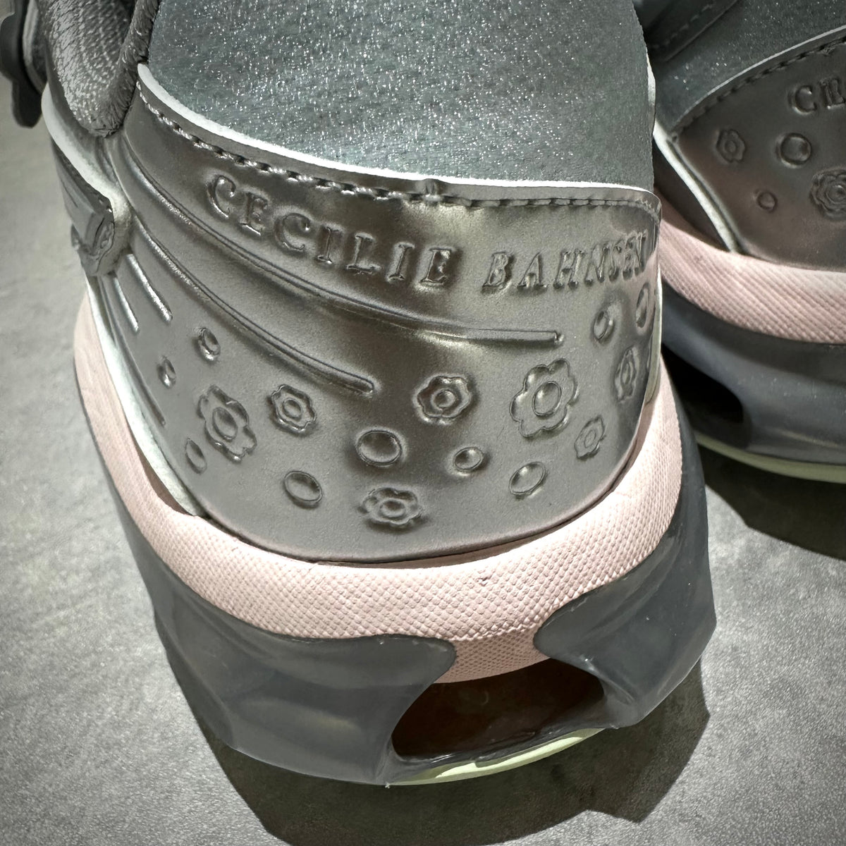 Close-up of Cecilie Bahnsen x Asics Gel-Kinetic FR heel detailing in Pure Silver color.