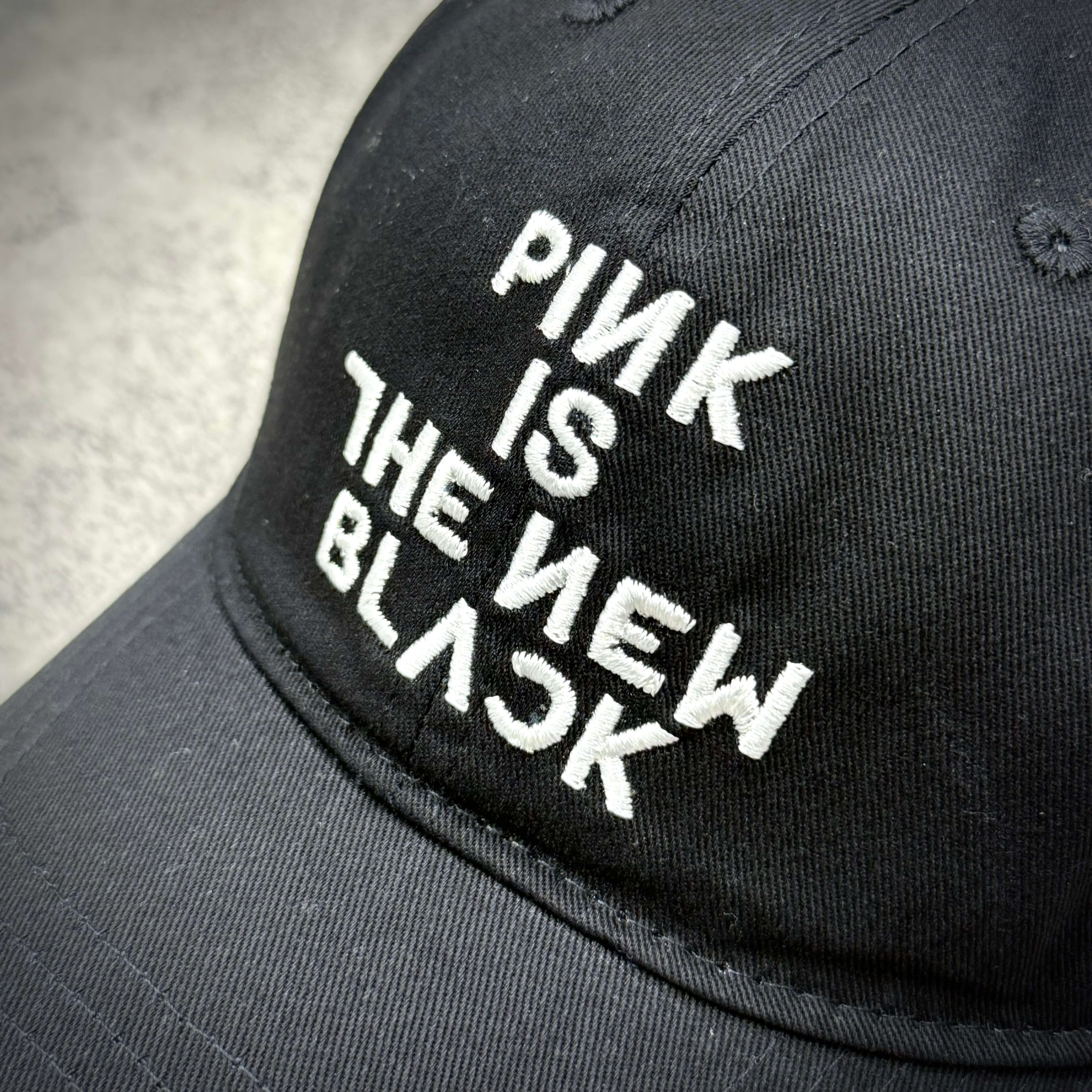 Fragment x Blackpink Cap featuring embroidered text "PINK IS THE NEW BLACK" on a black background.