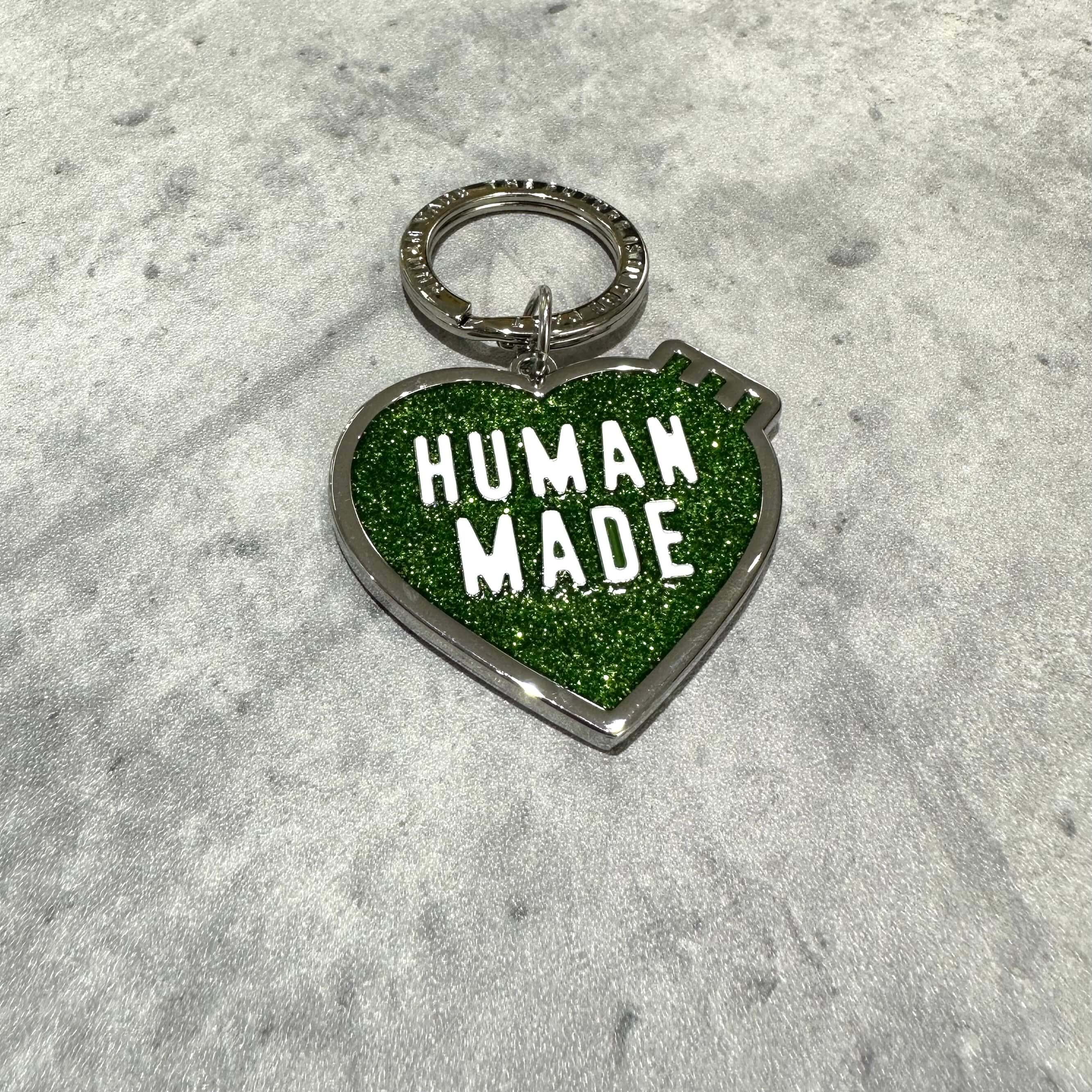 Human Made Store Exclusive Heart Keychain with green glitter finish and bold lettering.