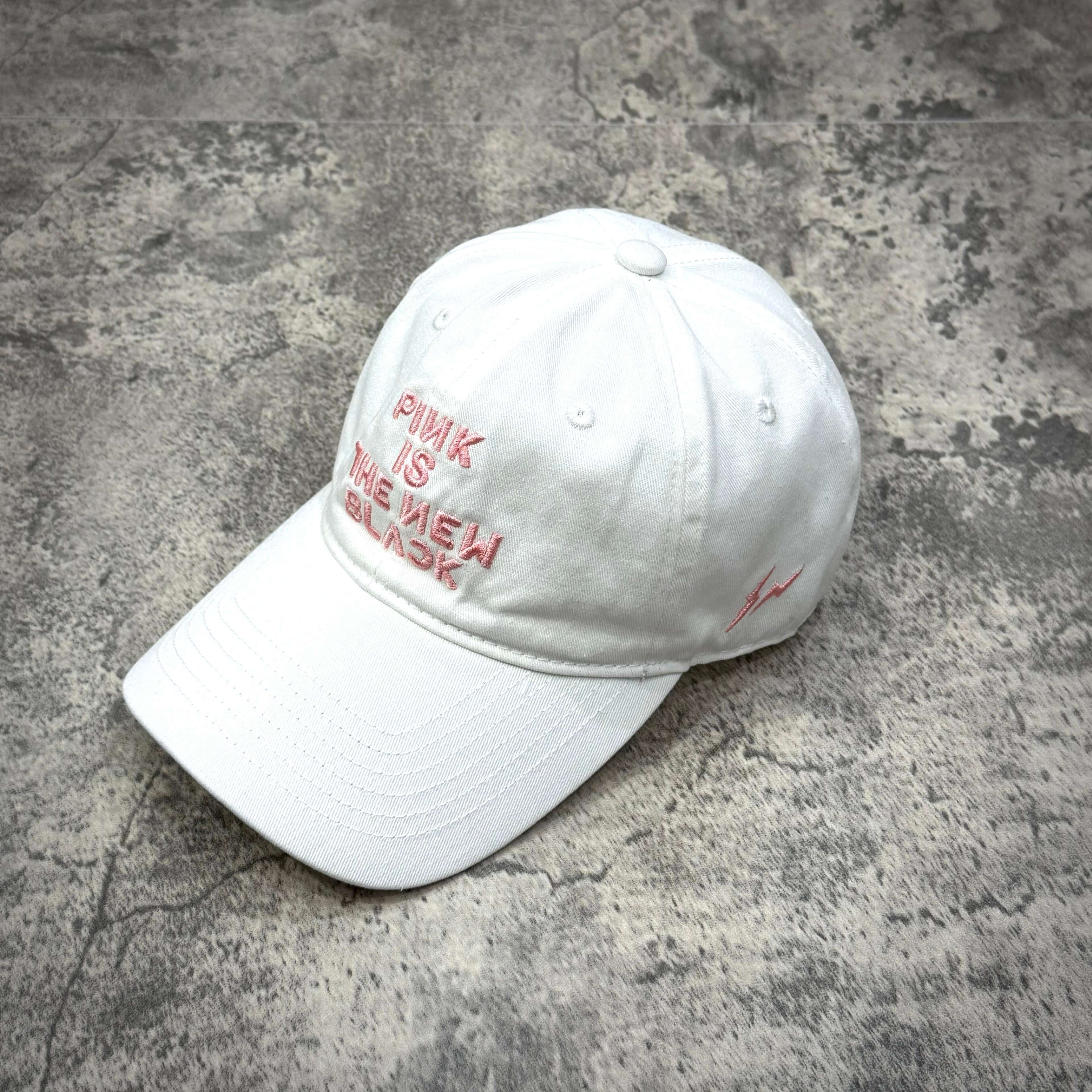 Fragment x Blackpink Cap featuring pink text 'PINK IS THE NEW BLACK' on a white baseball cap.