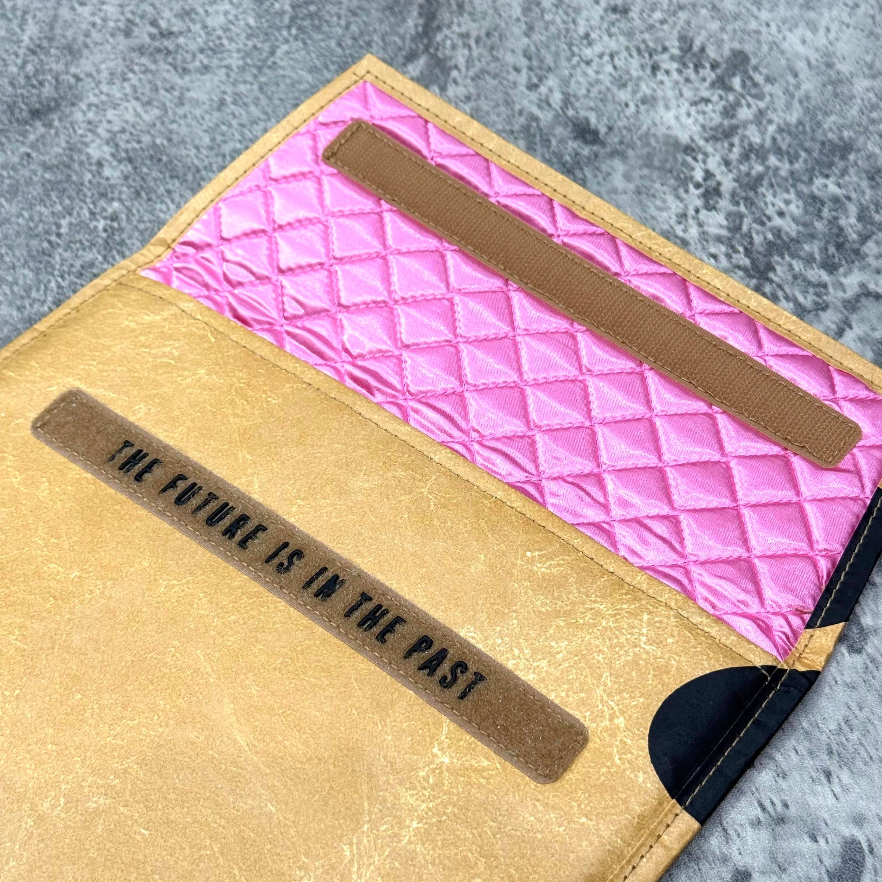 Inside view of the Human Made x VERDY Jamsil Exclusive Tablet Case, featuring pink lining and the phrase 'THE FUTURE IS IN THE PAST'.
