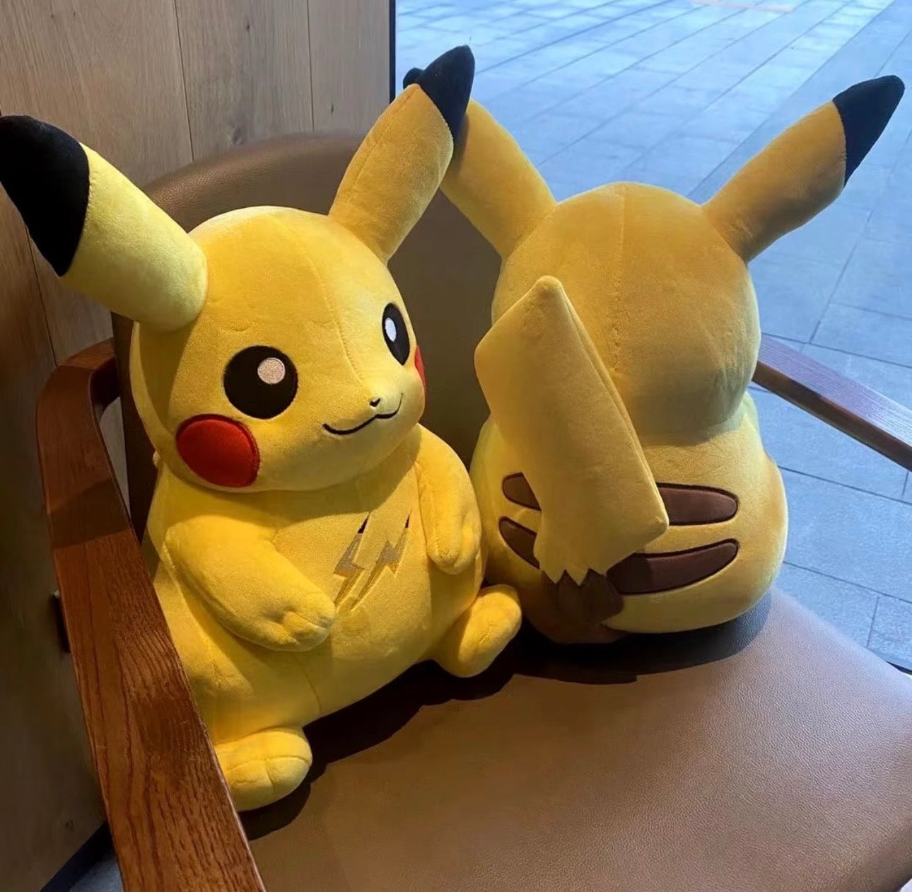 Pokemon x Thunderbolt Project by Fragment Pikachu Plush sitting on a chair, showcasing front and back view.