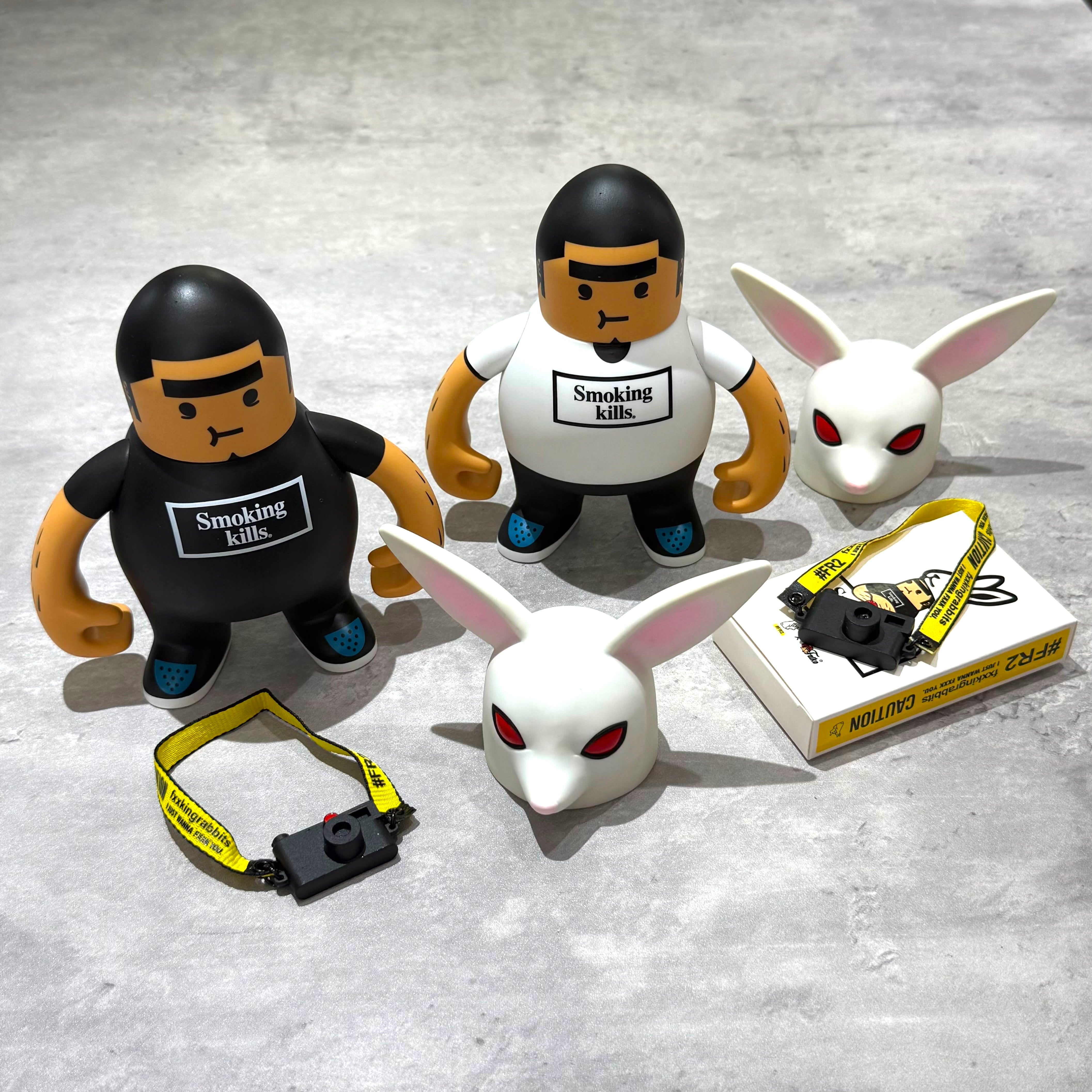 FR2 Fatko X FR2 Figure Doll - White/Black with accessories and additional figures on a gray background.
