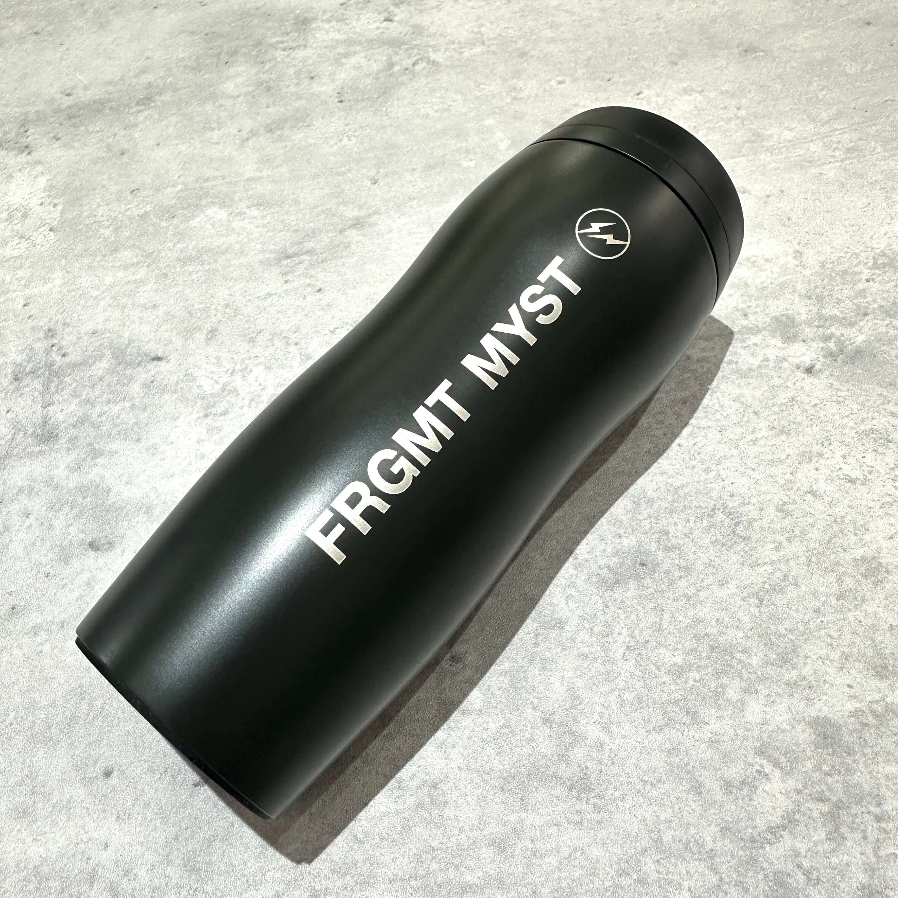 FRGMT MYST x STARBUCKS Curved Stainless Bottle in black, showcasing sleek design and logo.
