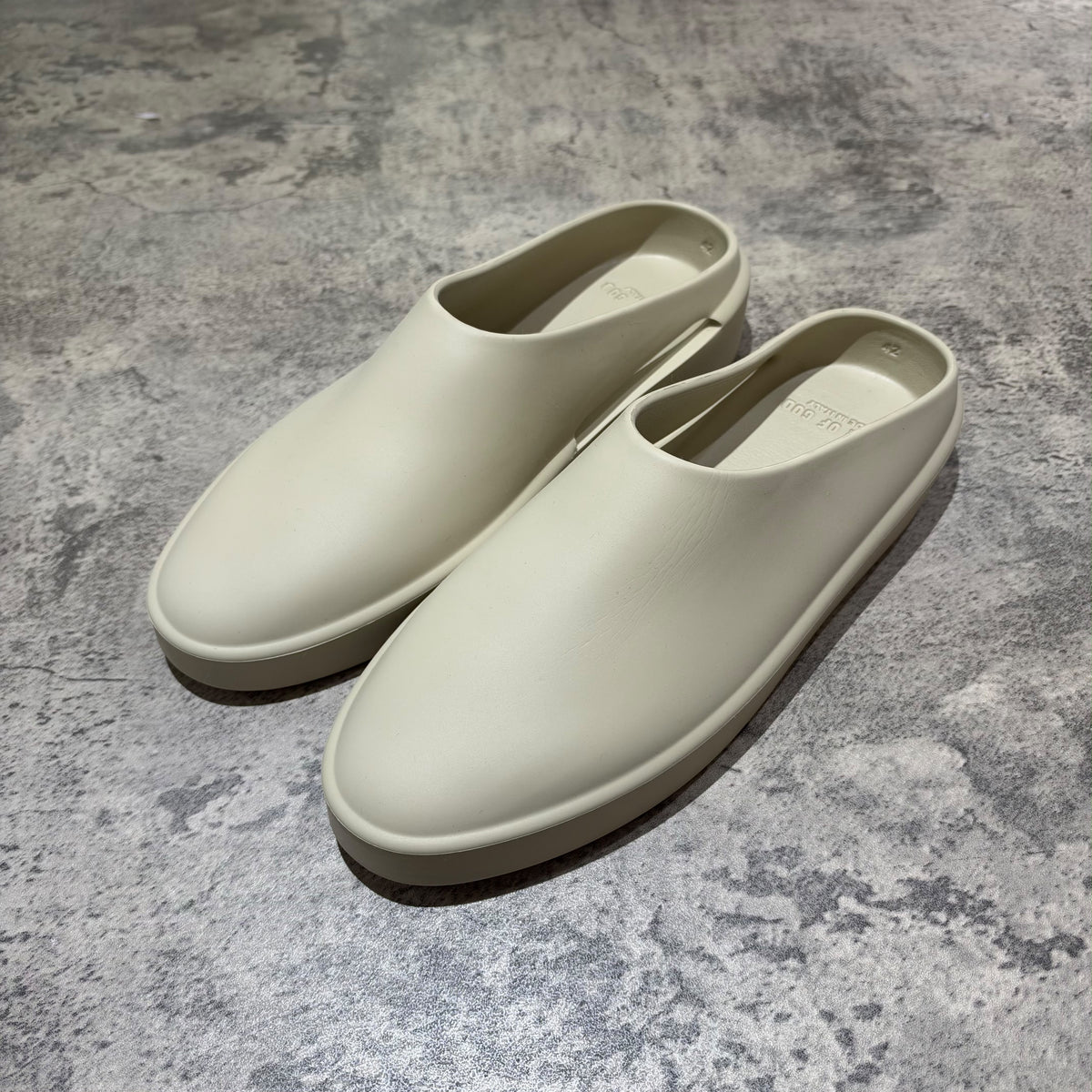 Fear of God The California Slip-on Oat FG80-100EVA in a soft beige color, showcasing a minimalist design.