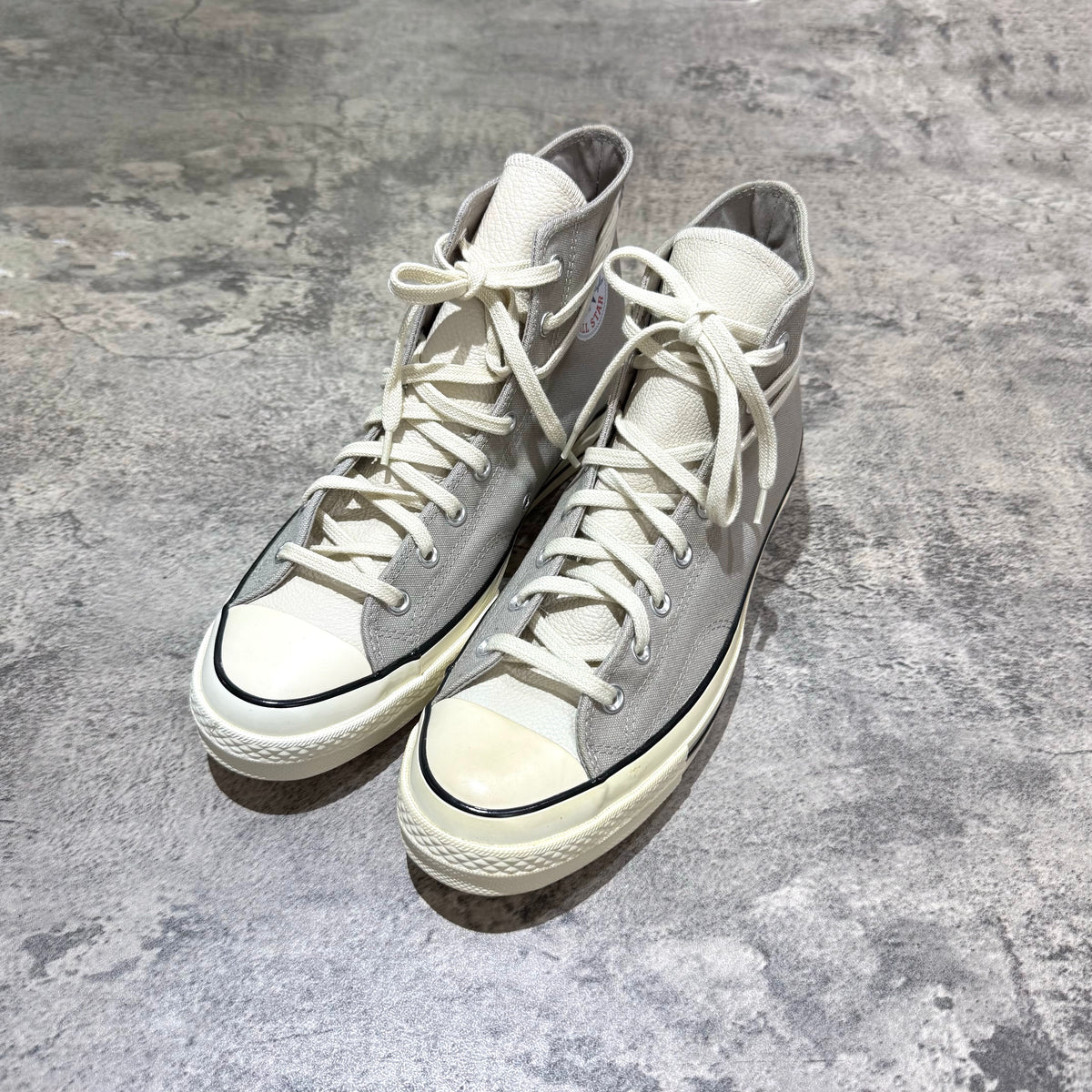 Fear Of God Essentials x Converse Chuck 70s Hi in white and grey, featuring high-top design and classic styling.