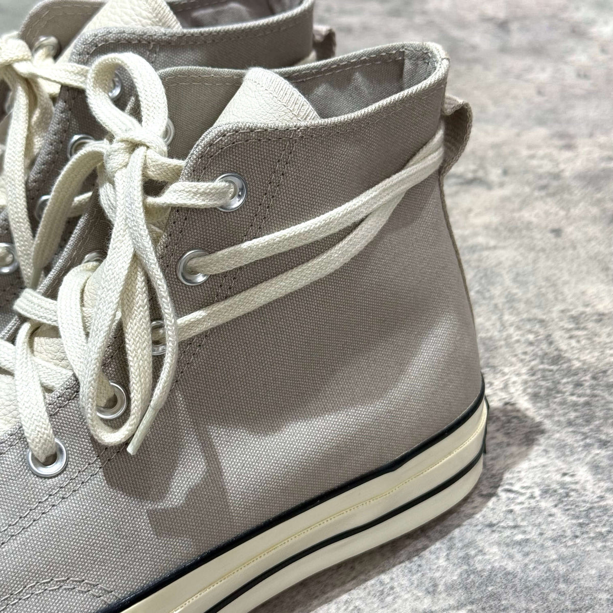 Fear Of God Essentials x Converse Chuck 70s Hi in White / Grey with laces and canvas material close-up.