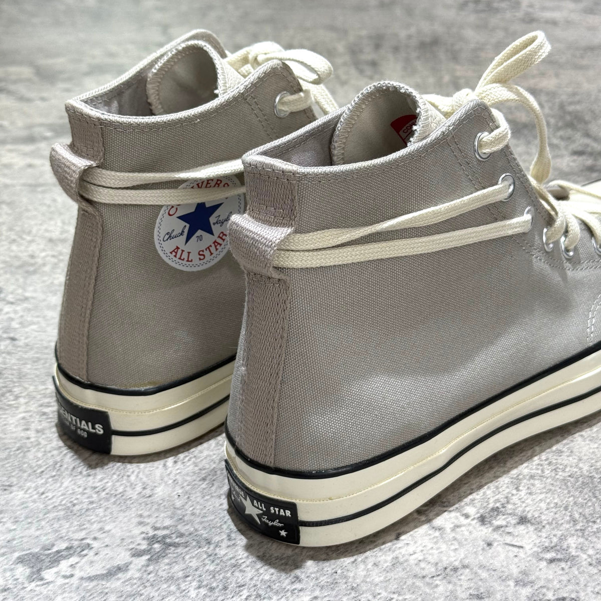 Fear Of God Essentials x Converse Chuck 70s Hi in White and Grey, stylish high-top sneakers with iconic logo.