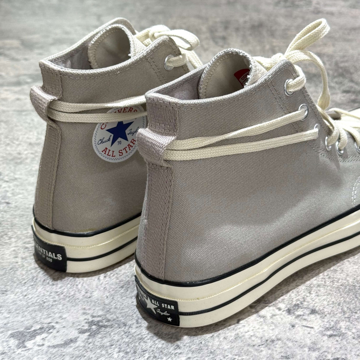 Fear Of God Essentials x Converse Chuck 70s Hi in White and Grey, stylish high-top sneakers with iconic logo.