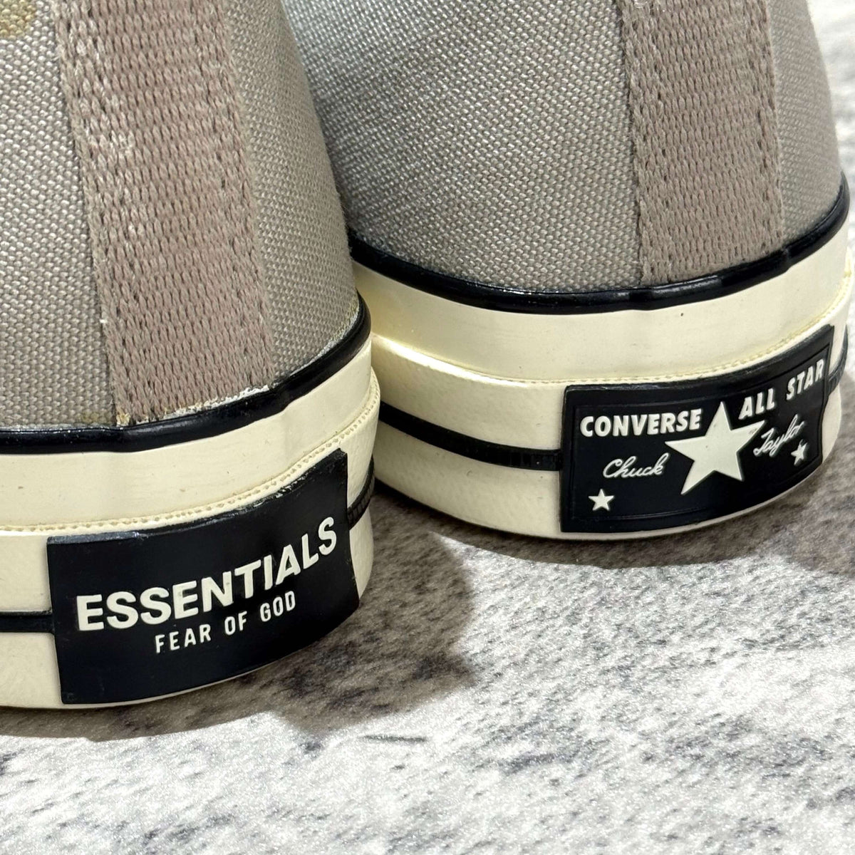 Fear Of God Essentials x Converse Chuck 70s Hi in White and Grey, featuring Essentials and Converse logos on the heel.