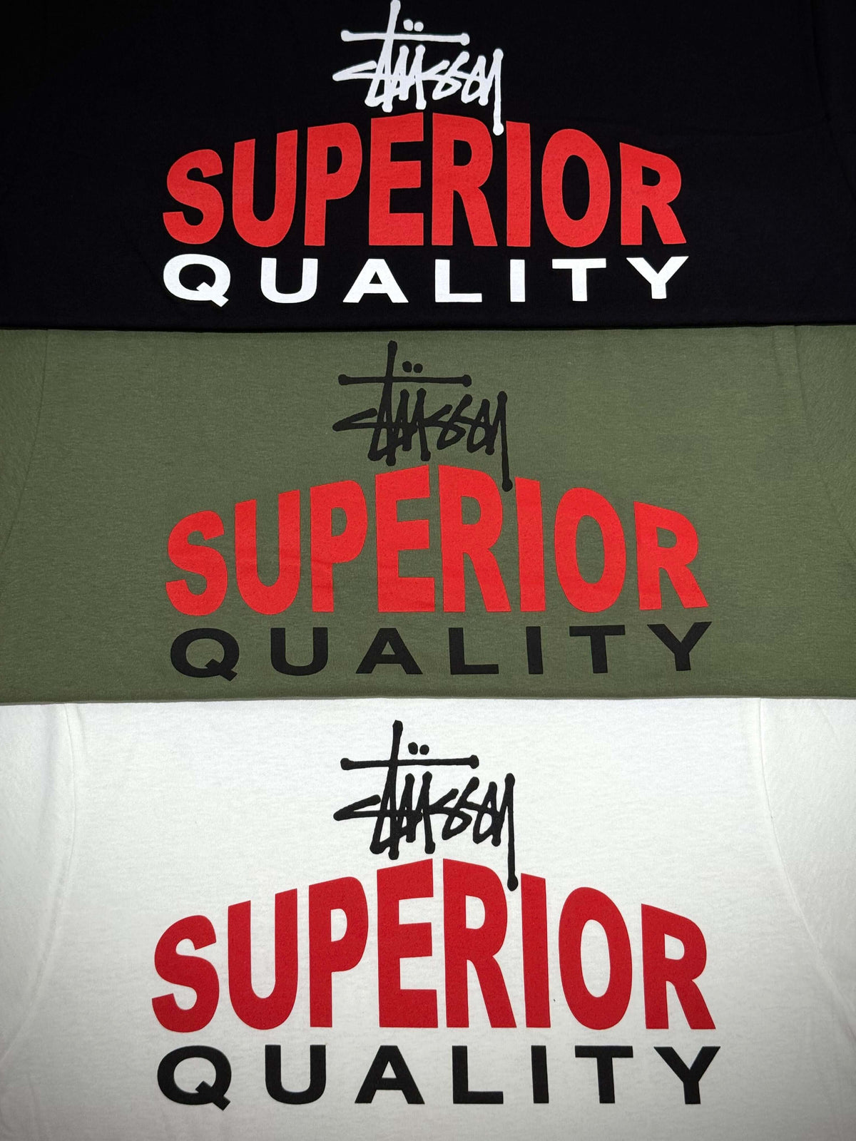 Stussy Superior Quality Tee - Black, Olive, and White displayed in a layered view showcasing vibrant graphics.