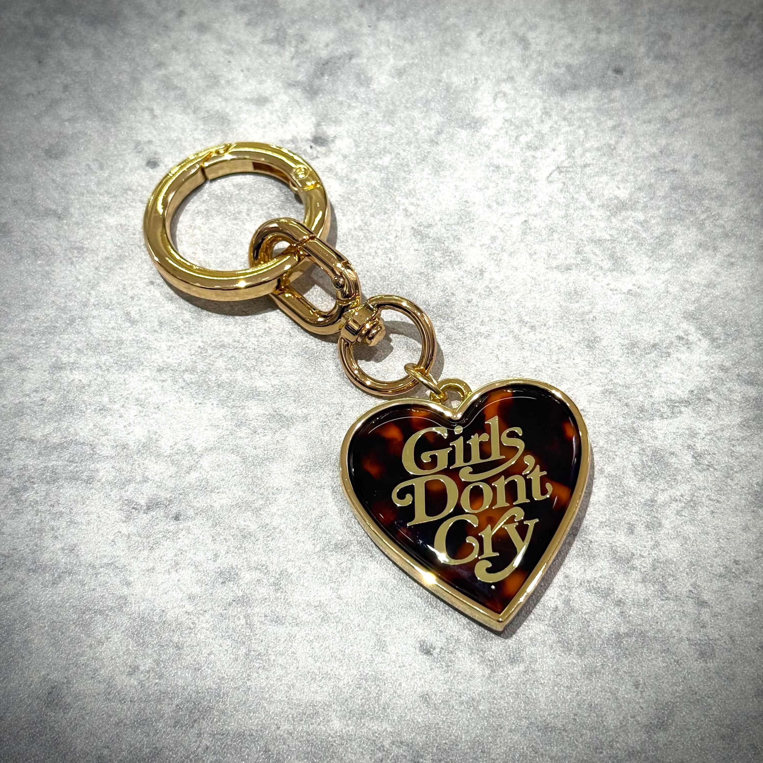 Girls Don't Cry Tortoise Shell Keyring with heart-shaped design and gold chain.