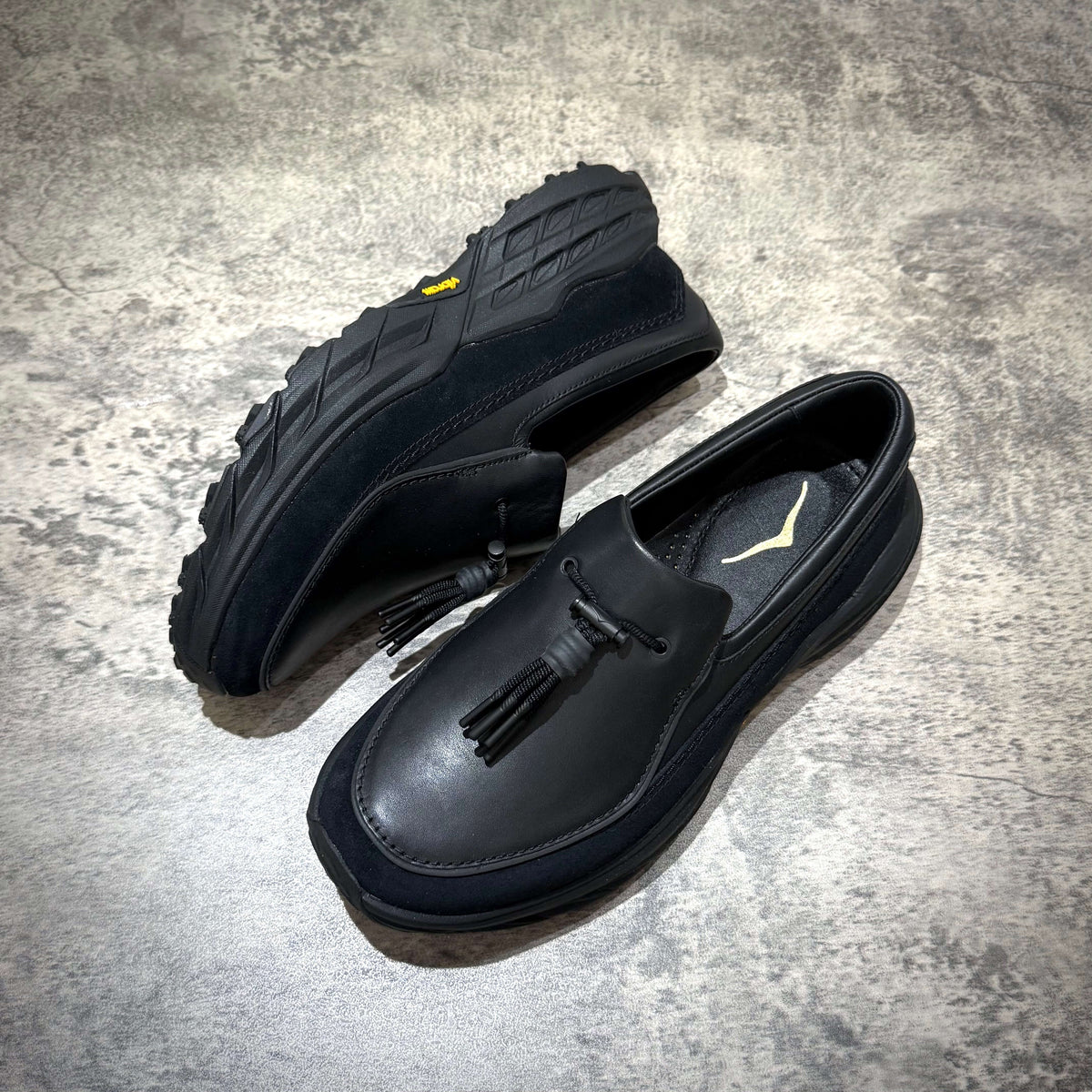 Hoka Speed Loafers - Black 1162170-BBLC showcasing stylish design and rugged outsole detail.