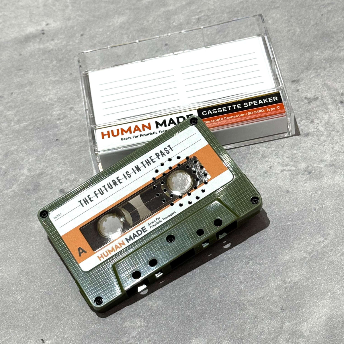 Human Made Cassette Speaker featuring retro design with a green cassette and clear packaging.
