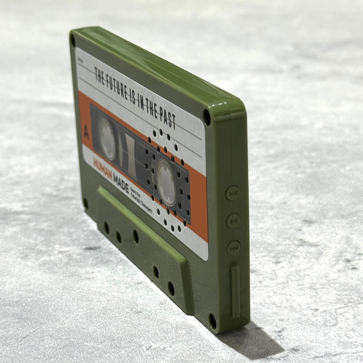 Human Made Cassette Speaker in green, showcasing retro design and modern audio technology.