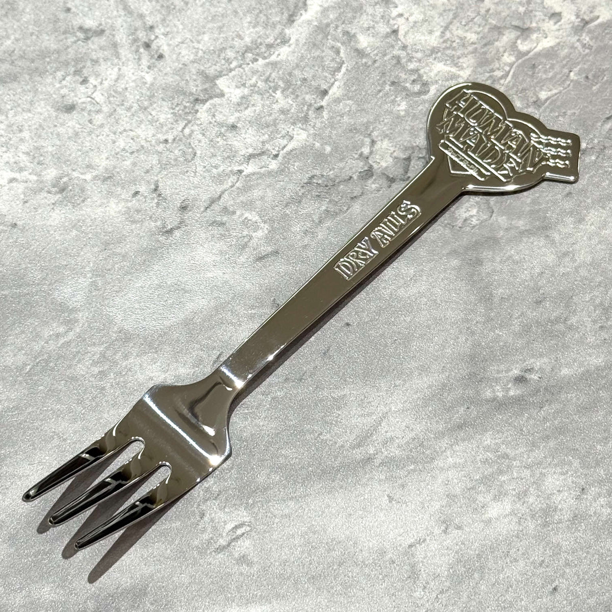 Human Made Cup Noodle Fork featuring a sleek design and embossed logo, ideal for enjoying Japanese convenience food.