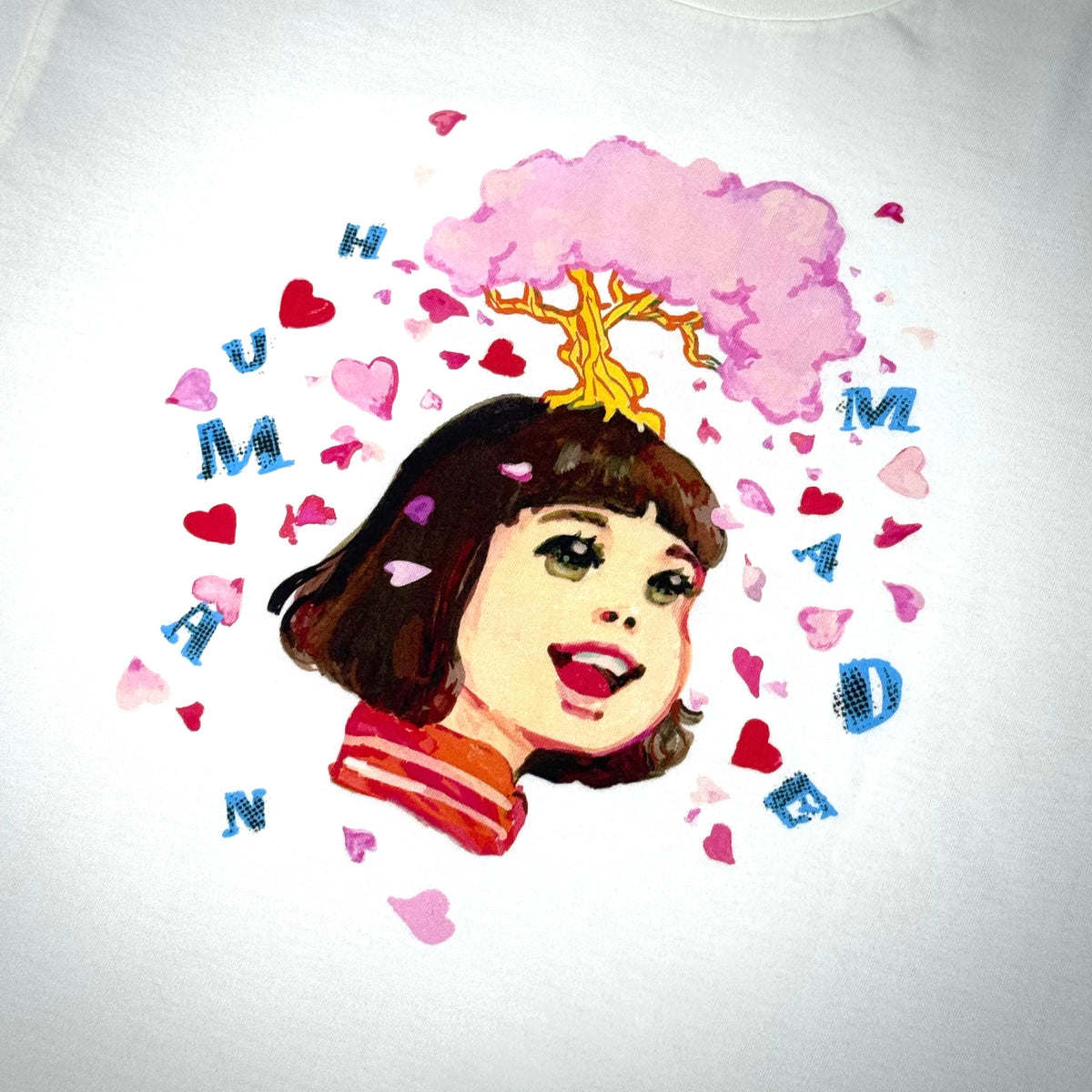 Human Made Keiko Sootome artwork featuring a whimsical illustration with hearts and a girl smiling.