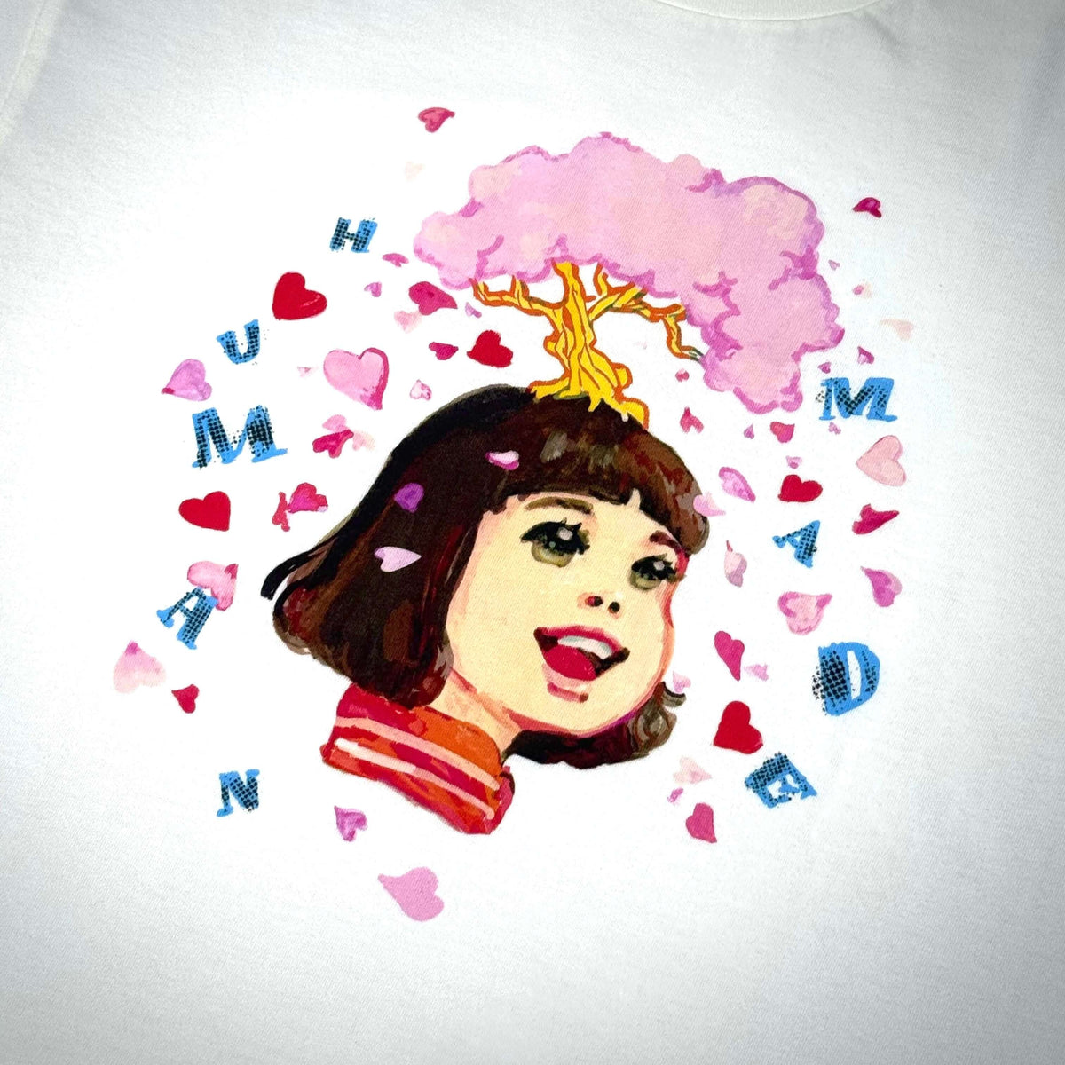 Human Made Keiko Sootome artwork featuring a whimsical illustration with hearts and a girl smiling.