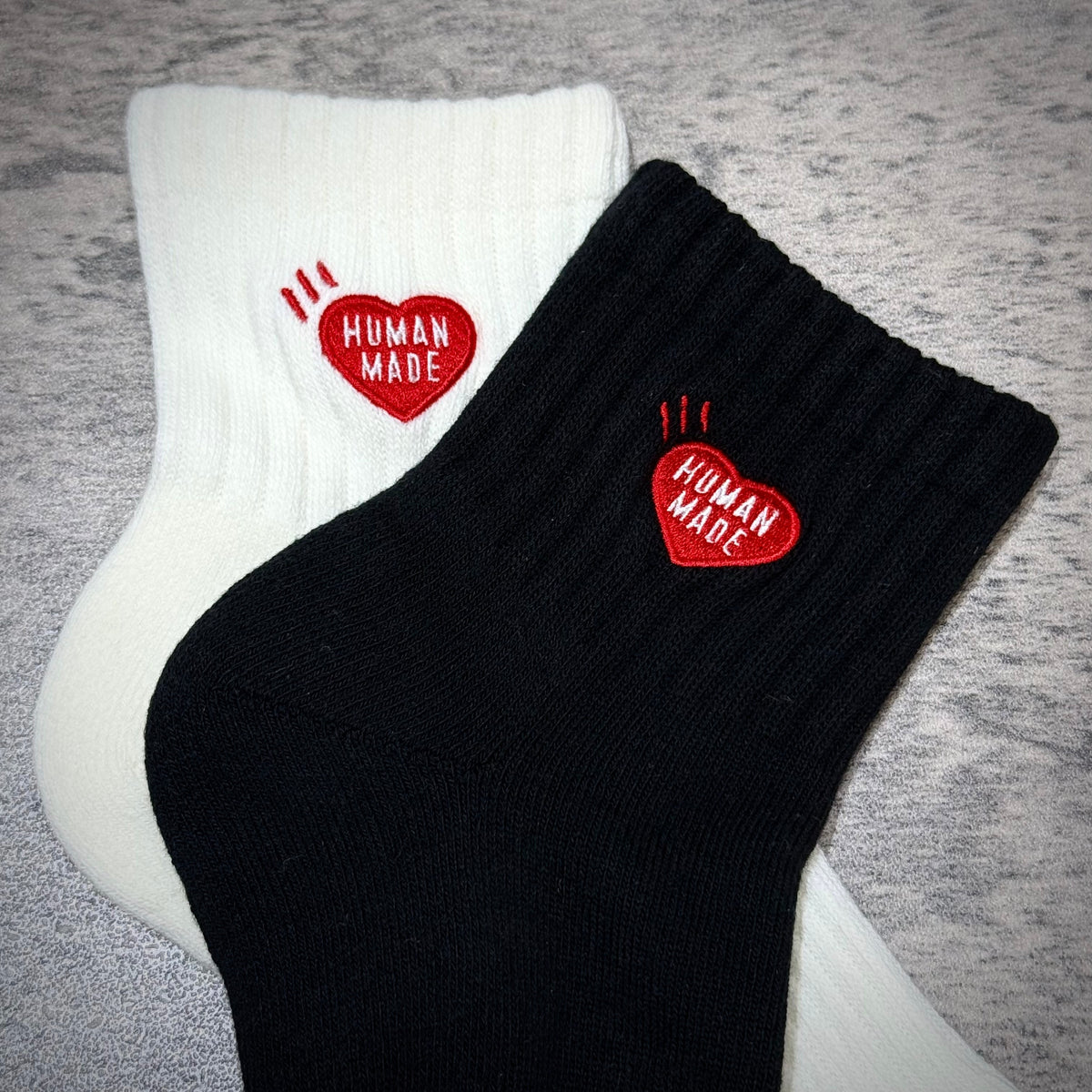 Human Made Pile Short Socks HM00GD009 featuring black and white color variations with heart logo.